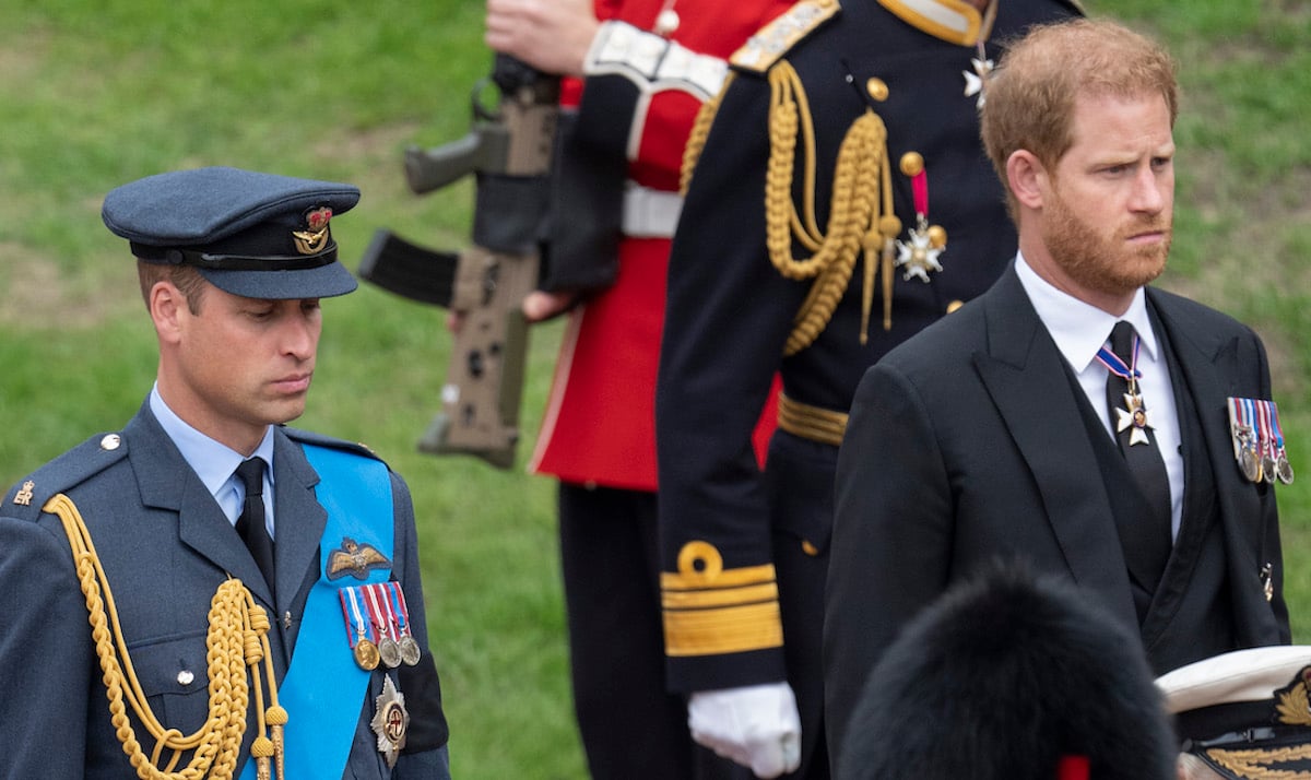 Prince William, who probably won't be 'damaged' by 'Harry & Meghan', according to a PR expert, stands near and Prince Harry