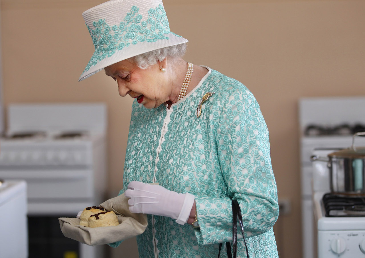 Queen Elizabeth II receives scones from the Clontarf kitchen during her visit to Clontarf Aboriginal college on October 27, 2011 in Perth, Australia.