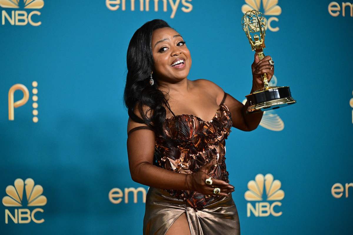 Quinta Brunson, a nominee for the 2022 Showbiz Social Media Awards, smiles holding an 'Abbott Elementary' Emmy