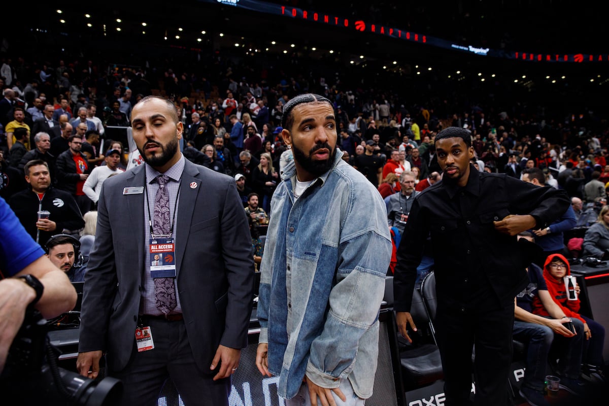 Rapper Drake waits for players at the end of the NBA game between the Toronto Raptors and the Brooklyn Nets