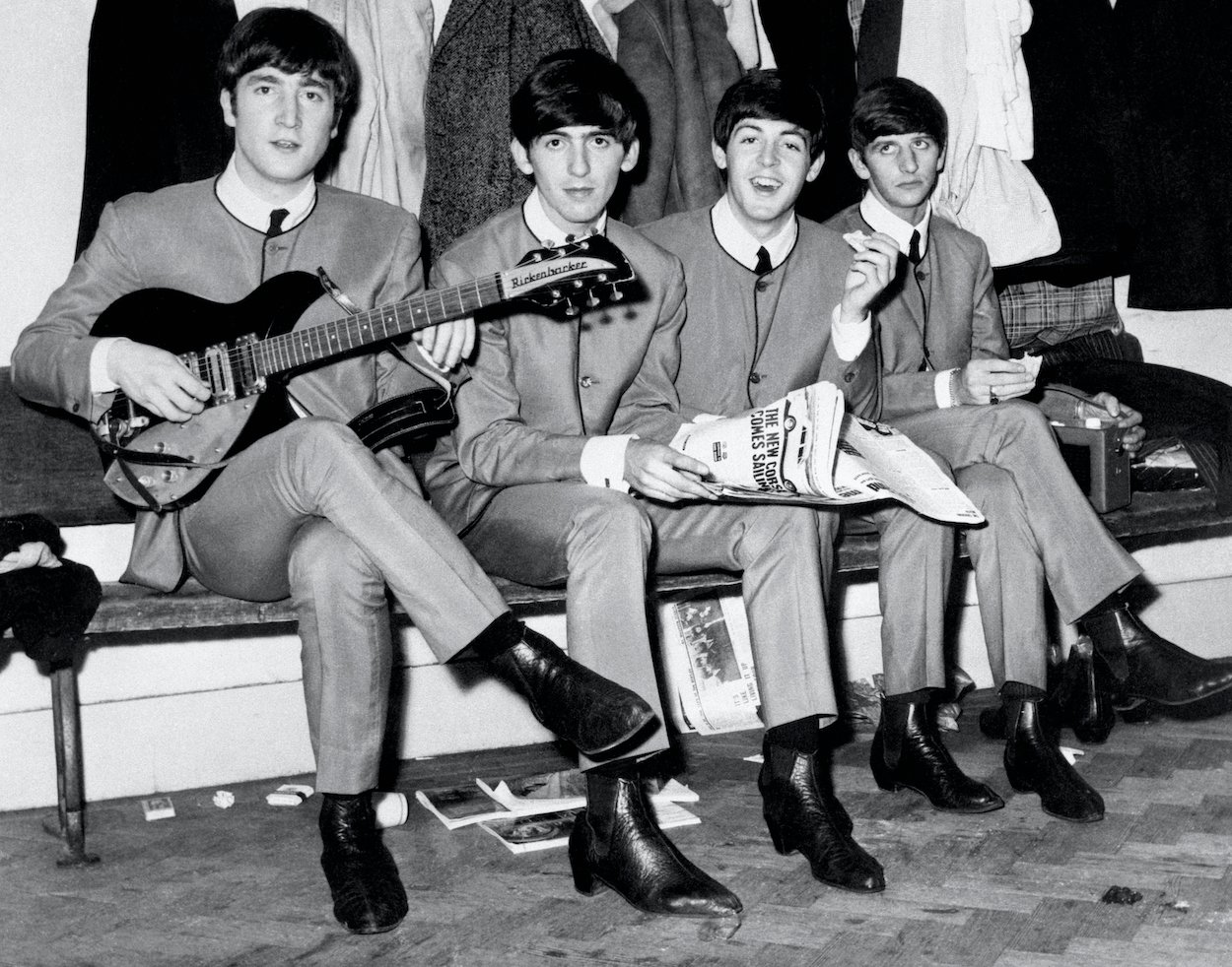 John Lennon (from left), George Harrison, Paul McCartney, and Ringo Starr sit on a bench in November 1963, roughly one year after Ringo joined The Beatles.