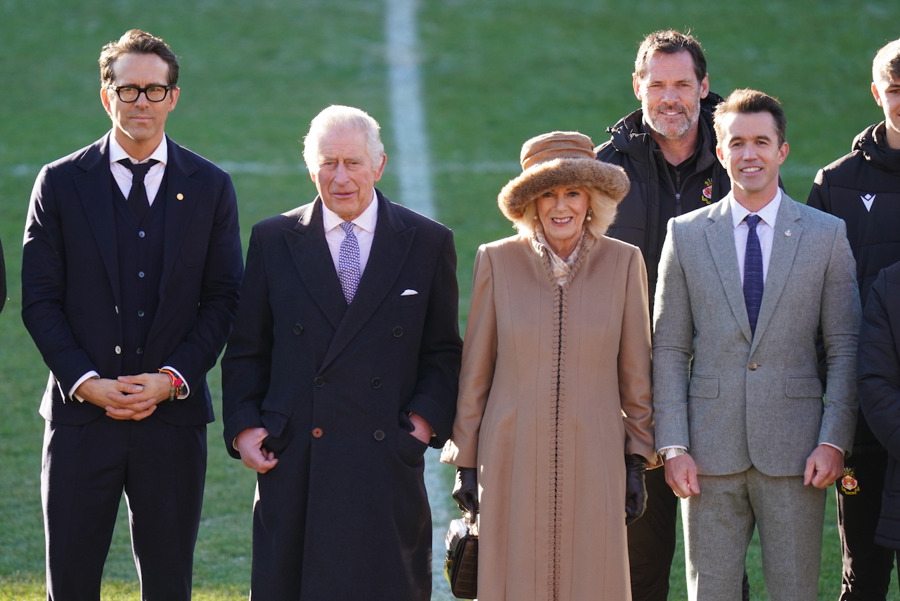King Charles III and the Queen Consort Camilla during their visit to Wrexham Association Football Club's Racecourse Ground, meeting owners and Hollywood actors, Ryan Reynolds (far left) and Rob McElhenney (far right), and players to learn about the redevelopment of the club, as part of their visit to Wrexham.