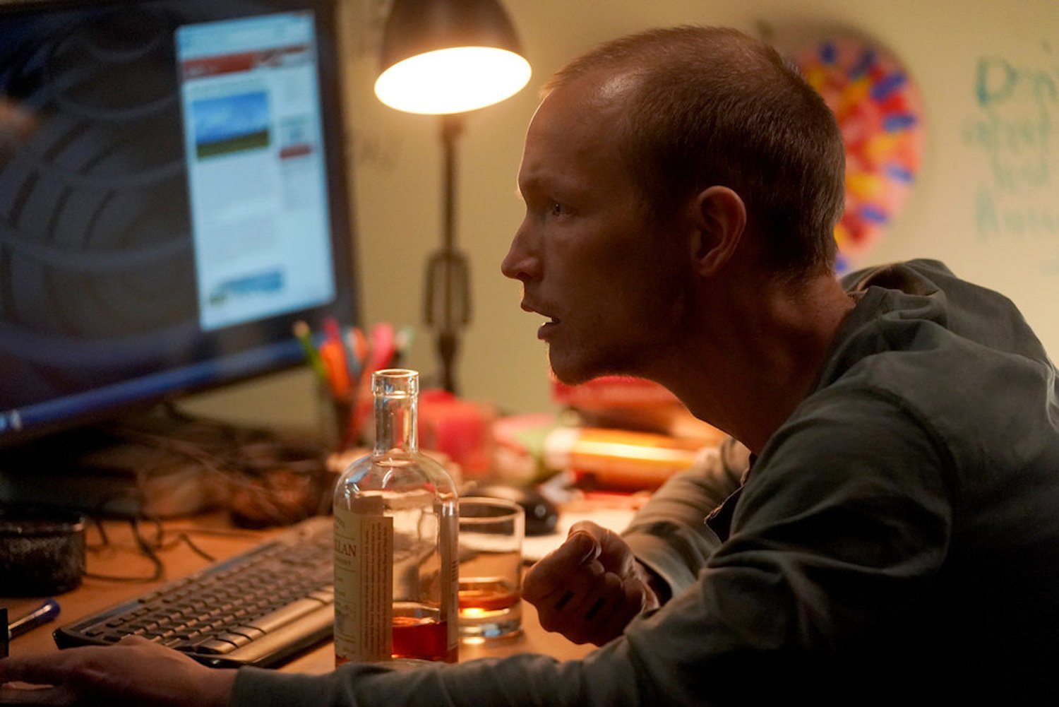 Sean O'Neal looking at a computer at a desk in 'Chicago P.D.' Season 10