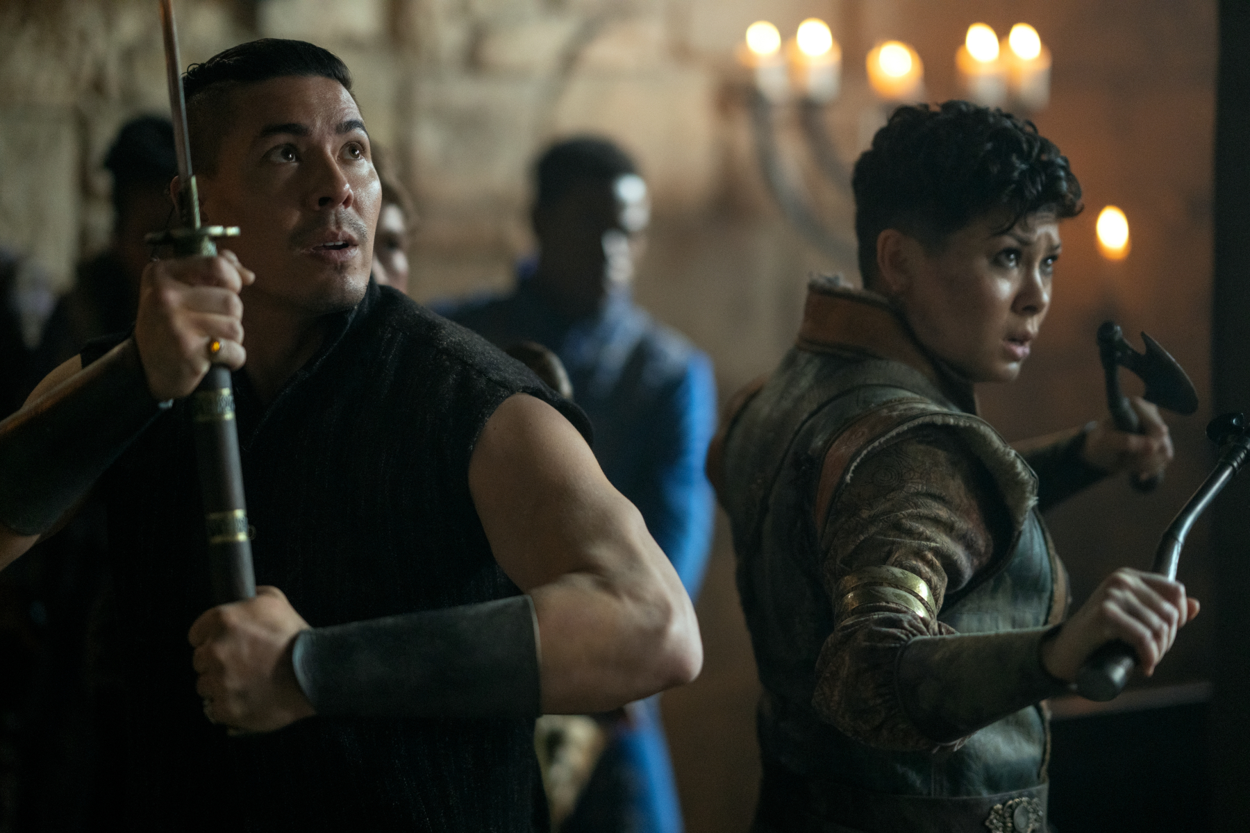 Lewis Tan and Anna Leong Brophy as Tolya and Tamar in 'Shadow and Bone' Season 2. They're holding up weapons and look ready to fight.