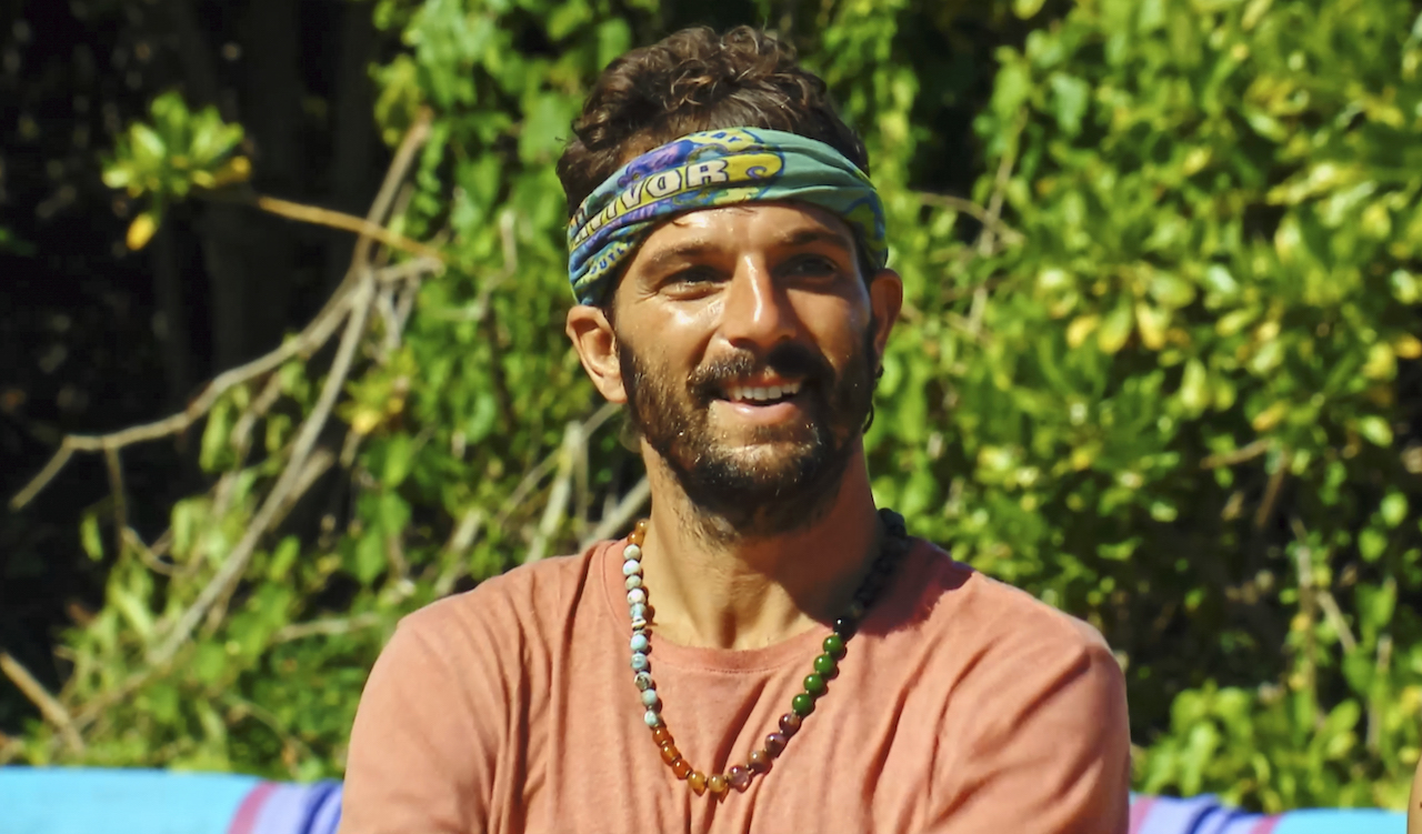 Cody Assenmacher wears a bead necklace and shirt on 'Survivor 43'.