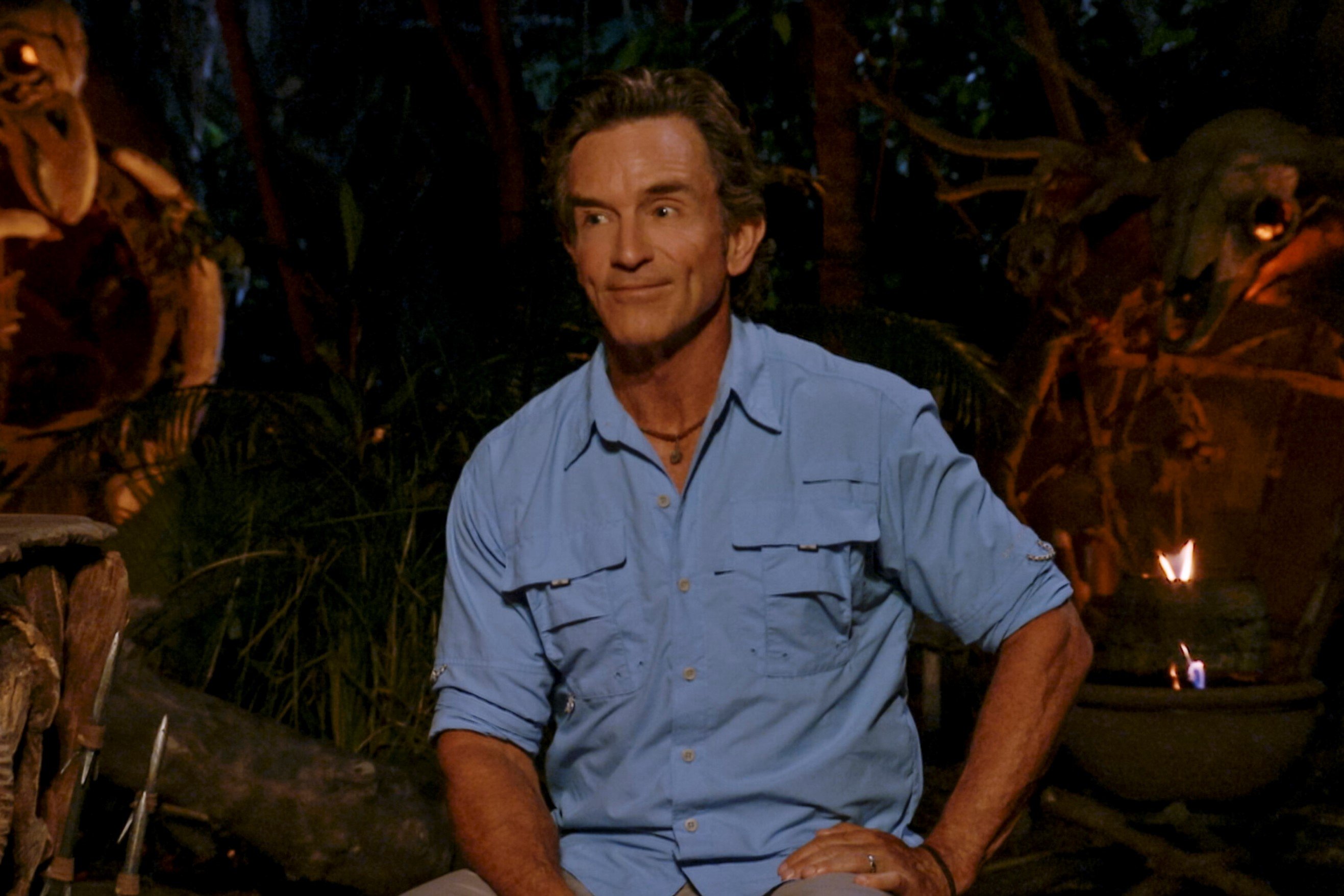 Jeff Probst, the host of 'Survivor 43' on CBS, wears a light blue button-up shirt with rolled-up sleeves at Tribal Council.
