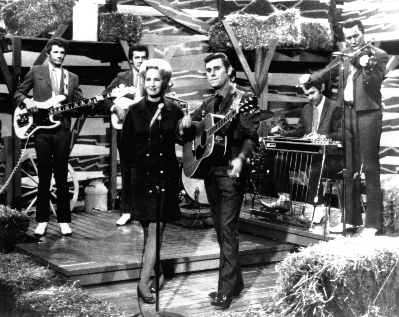 Tammy Wynette and George Jones performing on stage with the Jones Boys circa 1972.