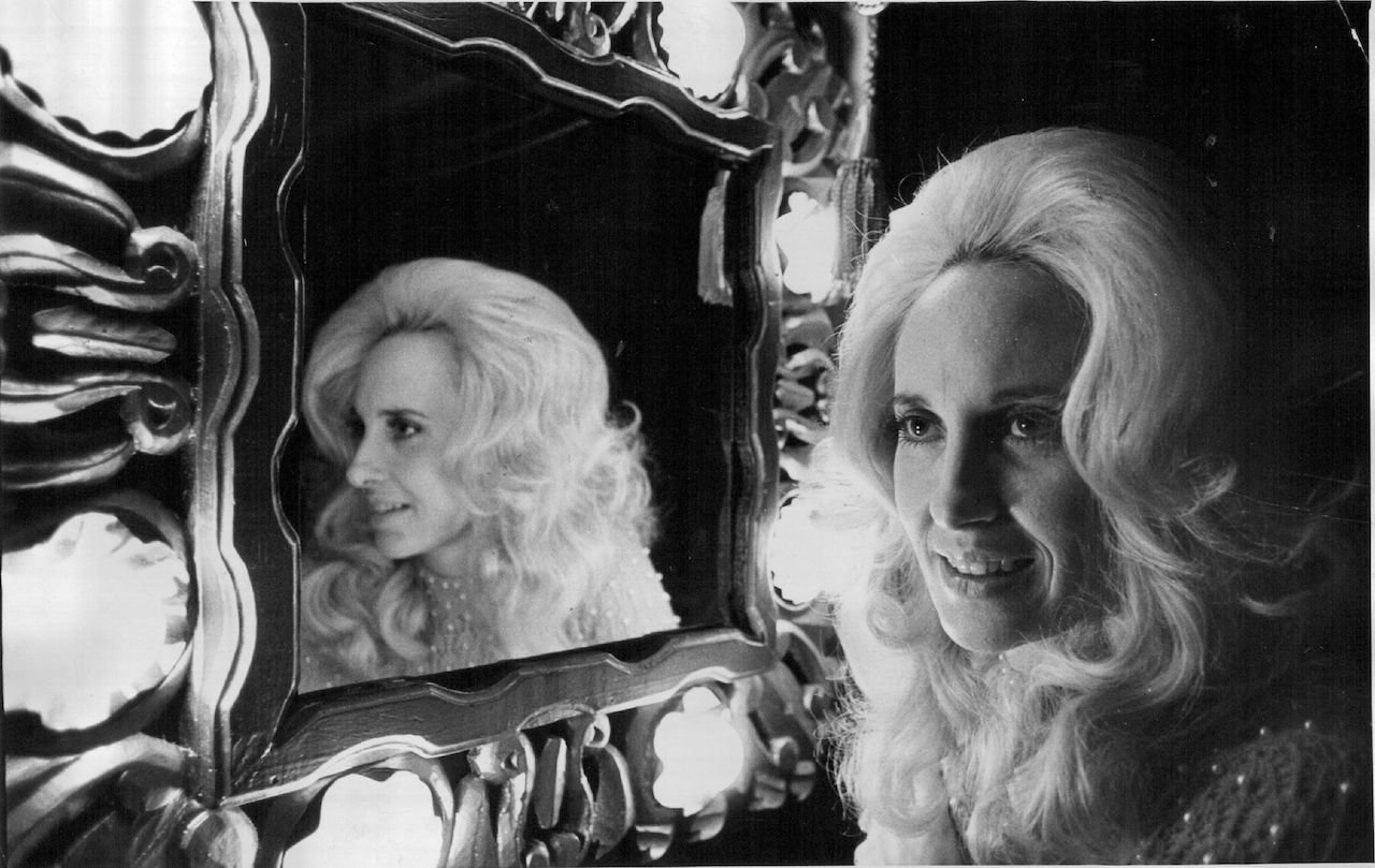 Country music star Tammy Wynette at the dressing room mirror aboard her tour bus c. 1975.
