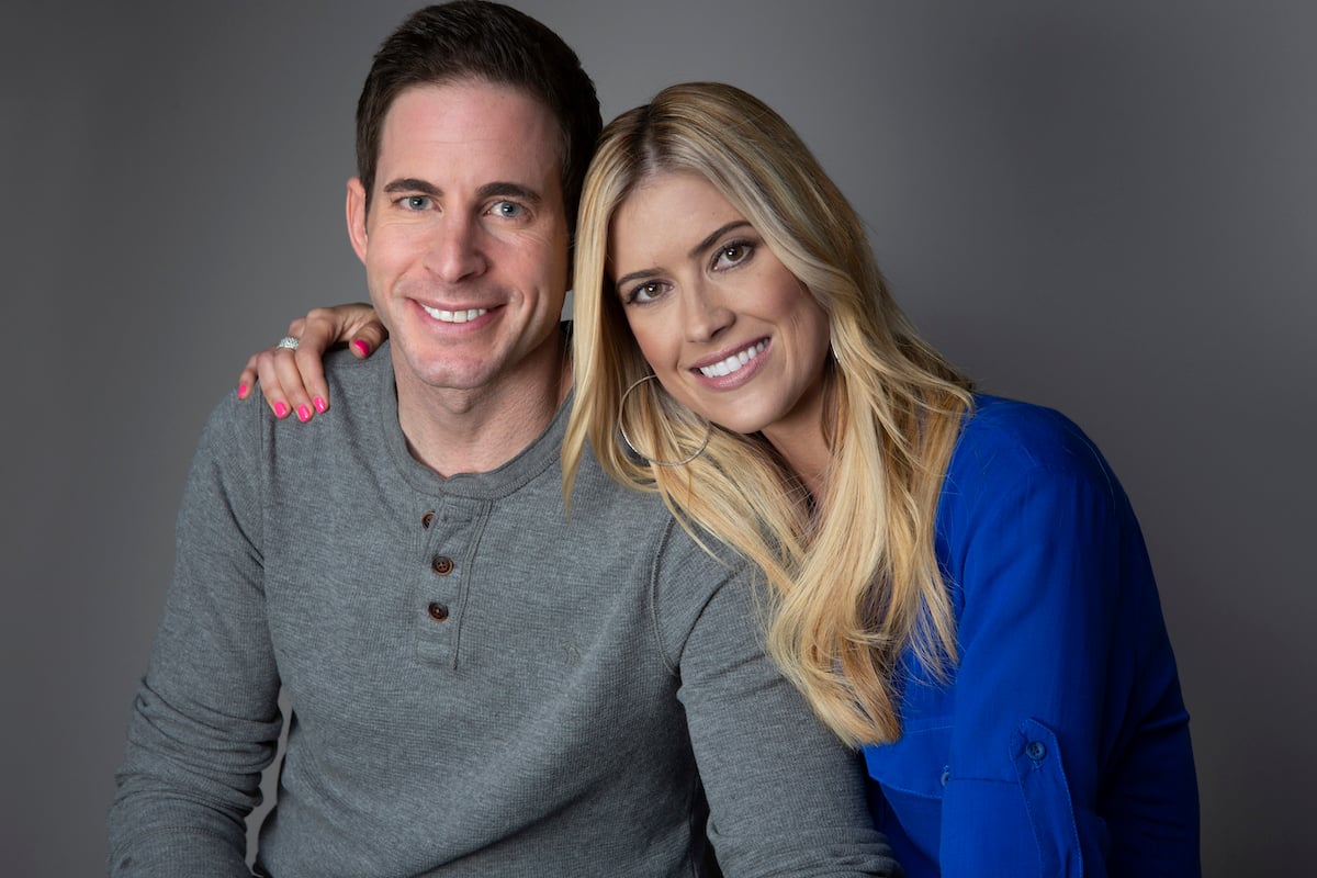 Tarek El Moussa and Christina Hall, who filmed their Final Flip together years after their divorce, smile and pose together for a portrait.