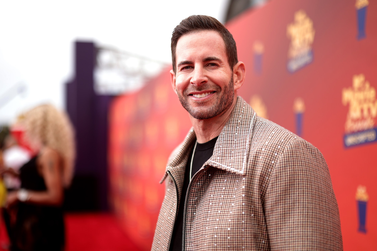 Tarek El Moussa, who overcame two types of cancer, smiles and poses at an event.