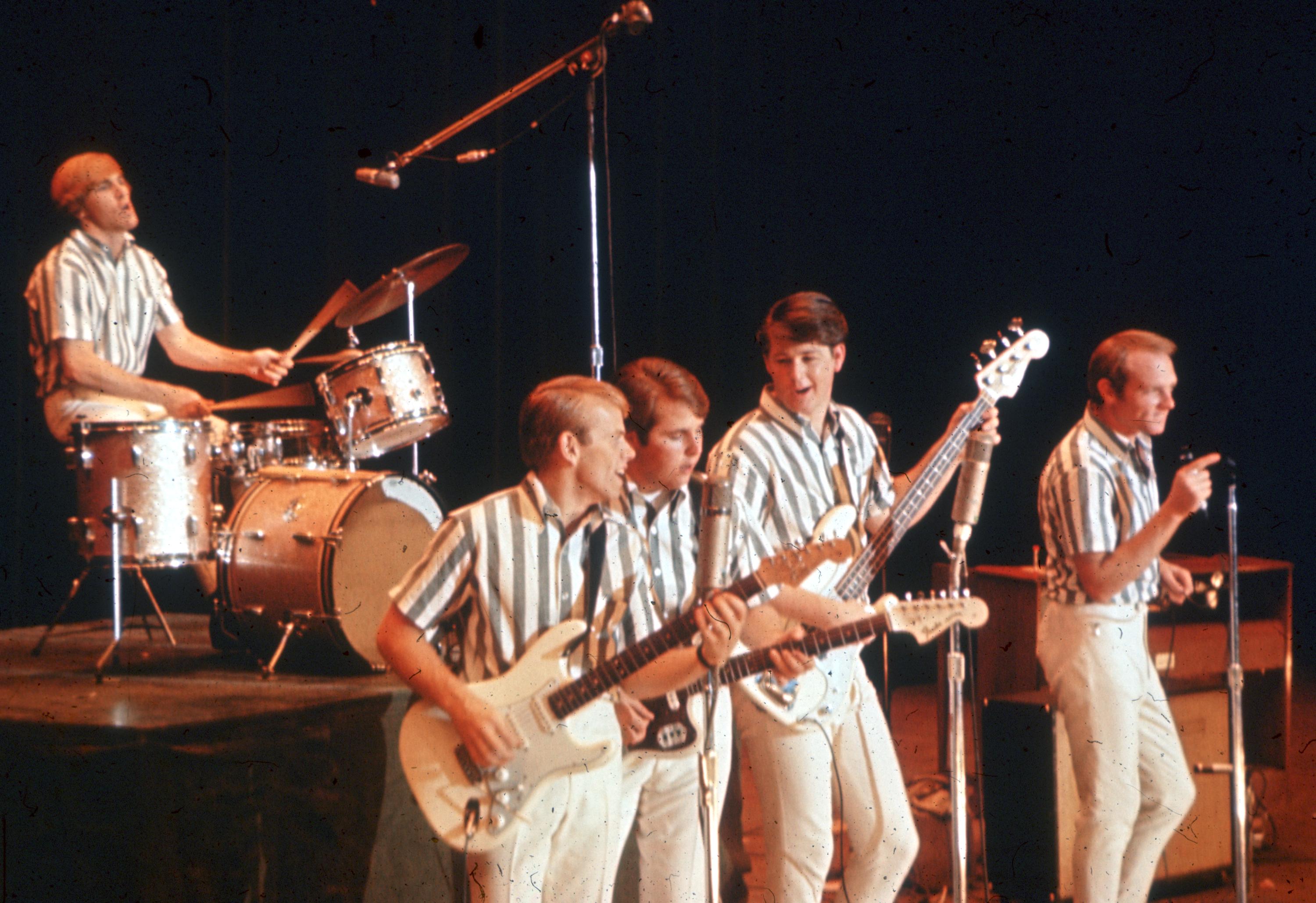 Rock and roll band The Beach Boys perform on stage in 1964 (Dennis Wilson, Al Jardine, Carl Wilson, Brian Wilson, Mike Love)