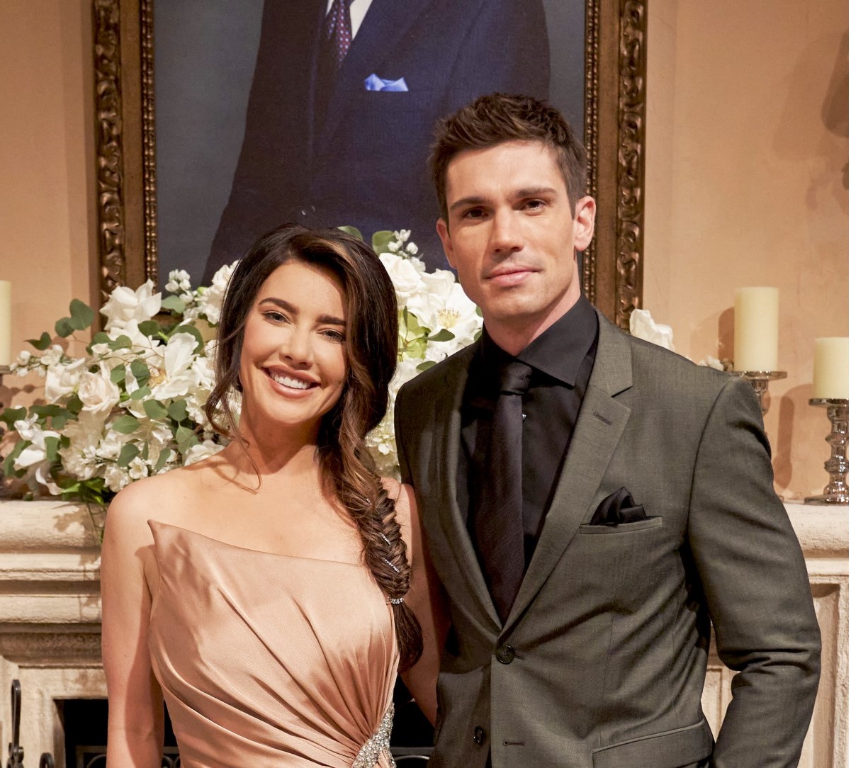 'The Bold and the Beautiful' star Jacqueline MacInnes Wood in a champagne colored dress and Tanner Novlan in a grey suit; pose together in the Forrester living room.