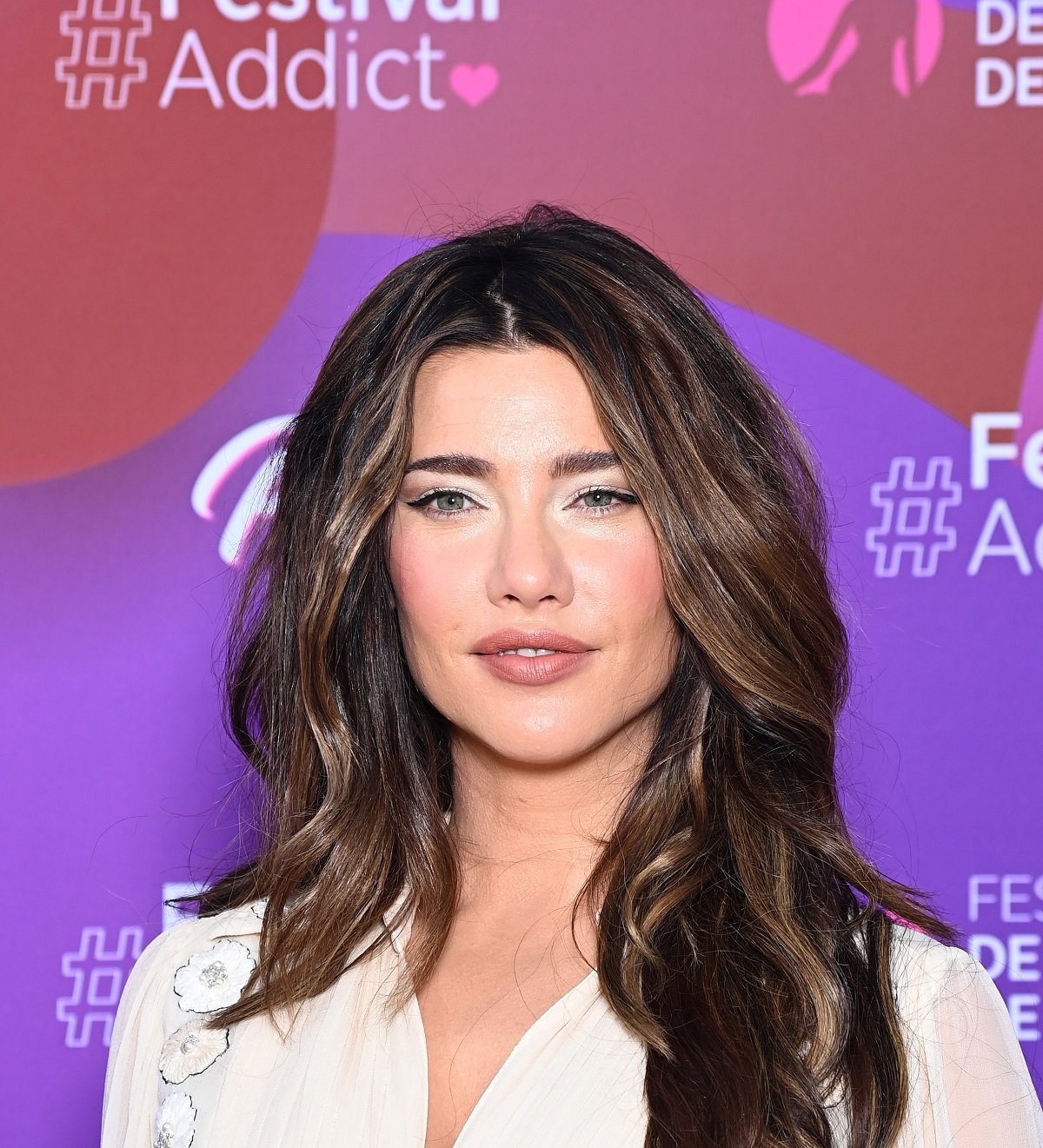 'The Bold and the Beautiful' star Jacqueline MacInnes Wood wearing a white dress and smiling during a red carpet appearance.