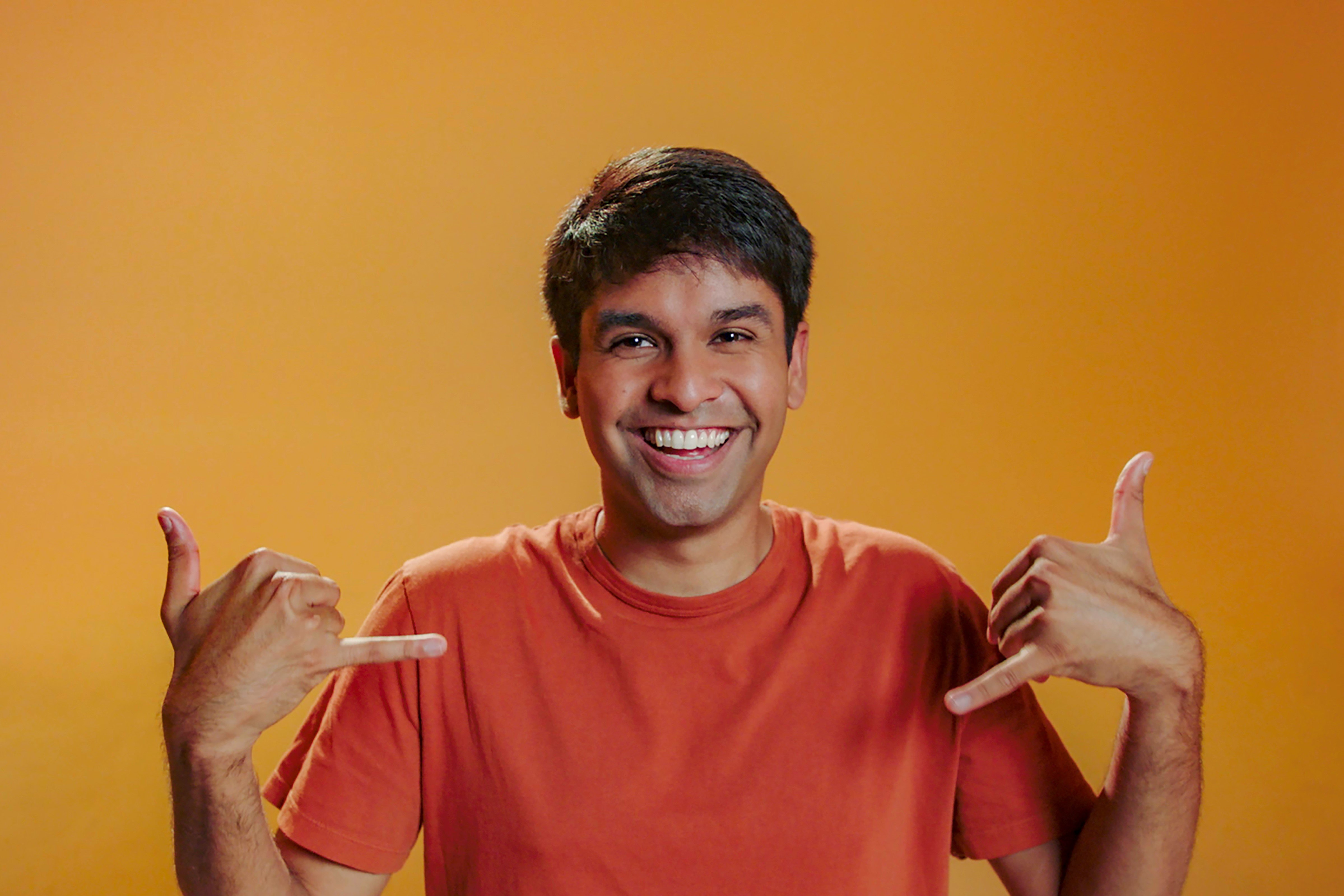 Shubham Goel, who stars in 'The Circle' Season 5 on Netflix, wears an orange shirt.