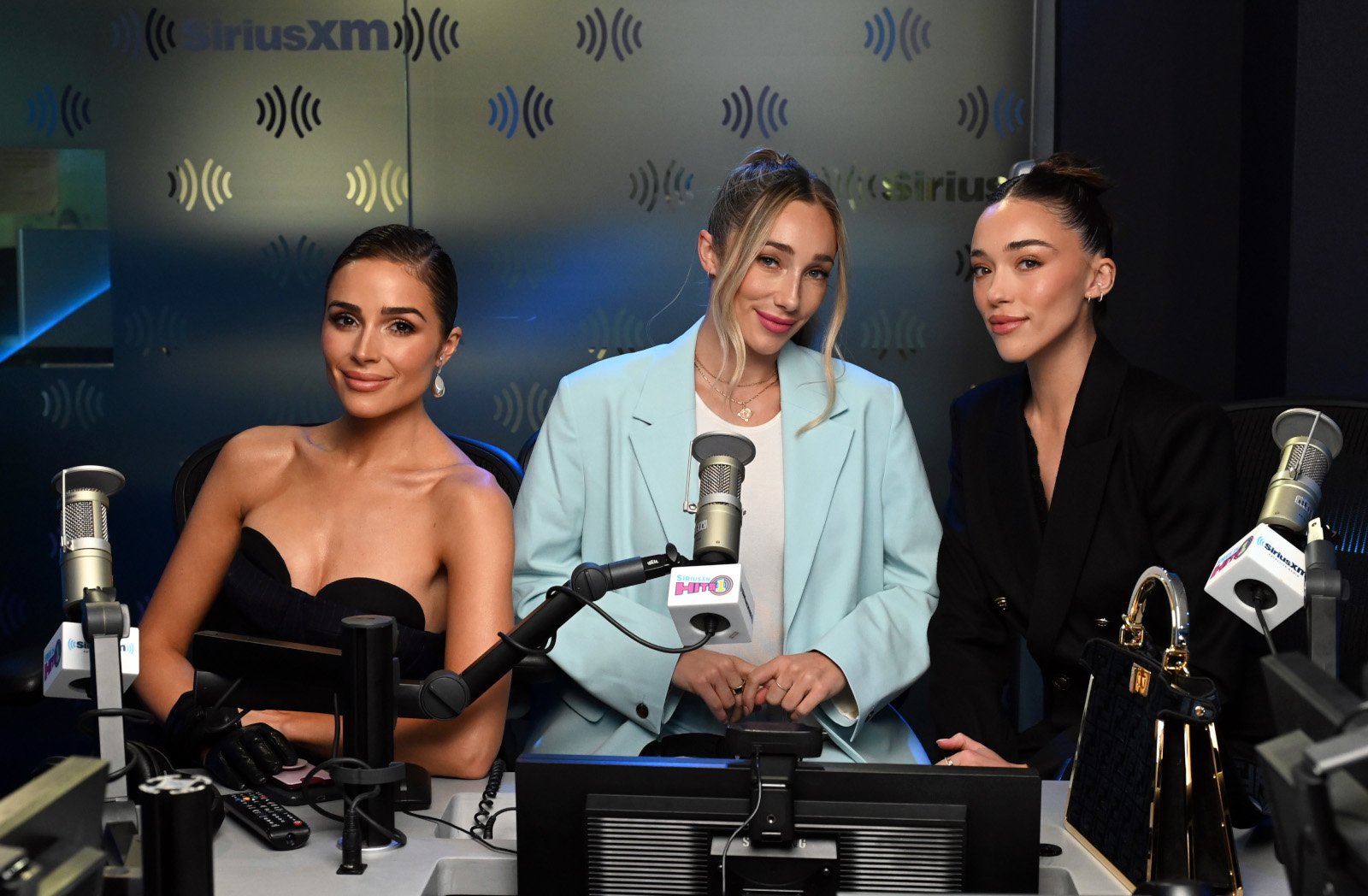 'The Culpo Sisters' stars Olivia, Aurora, and Sophia Culpo. They're sitting in front of microphones during an appearance on 'The Morning Mash Up.'