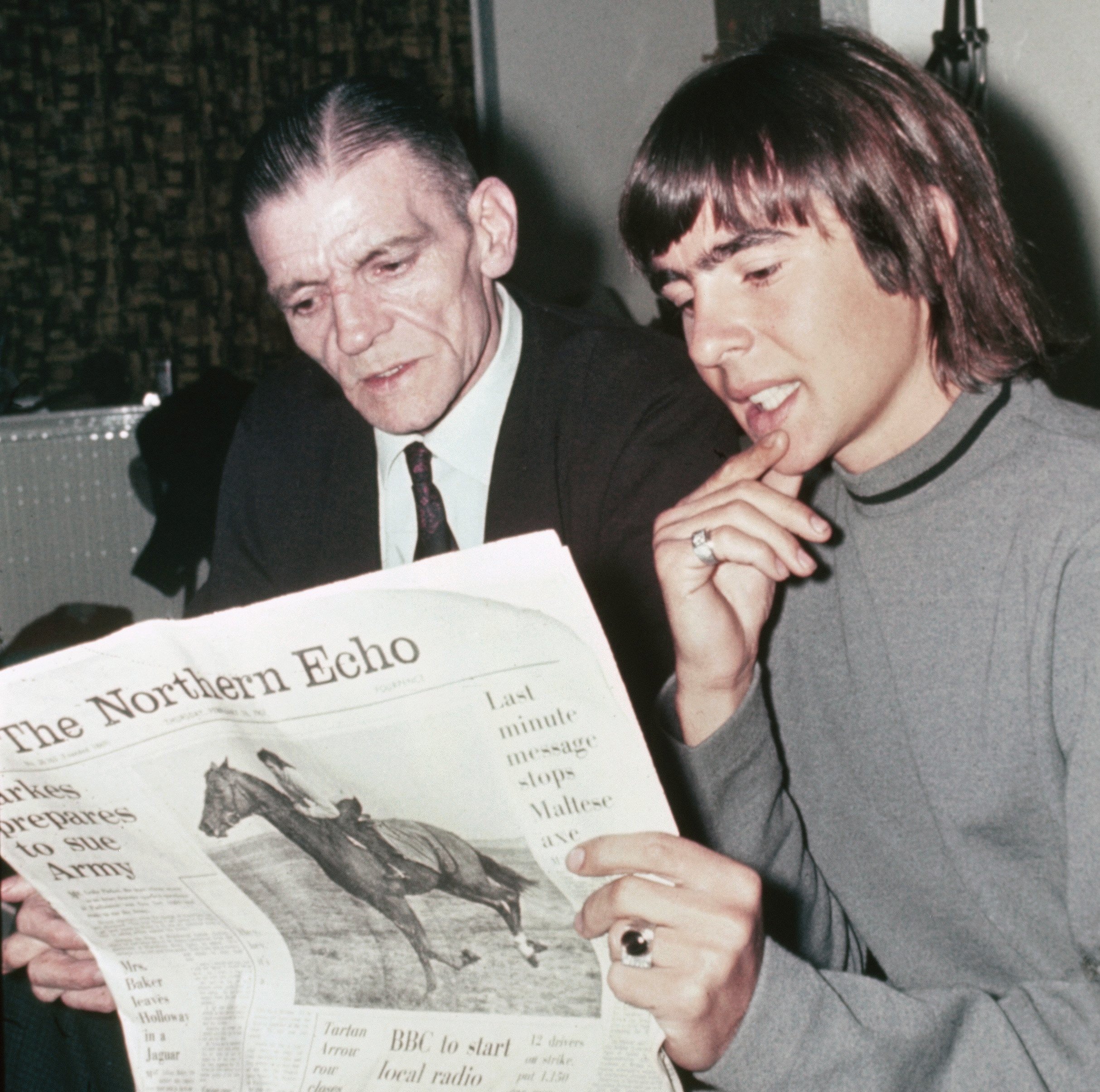 The Monkees' Davy Jones and his father, Harry Jones, with a newspaper