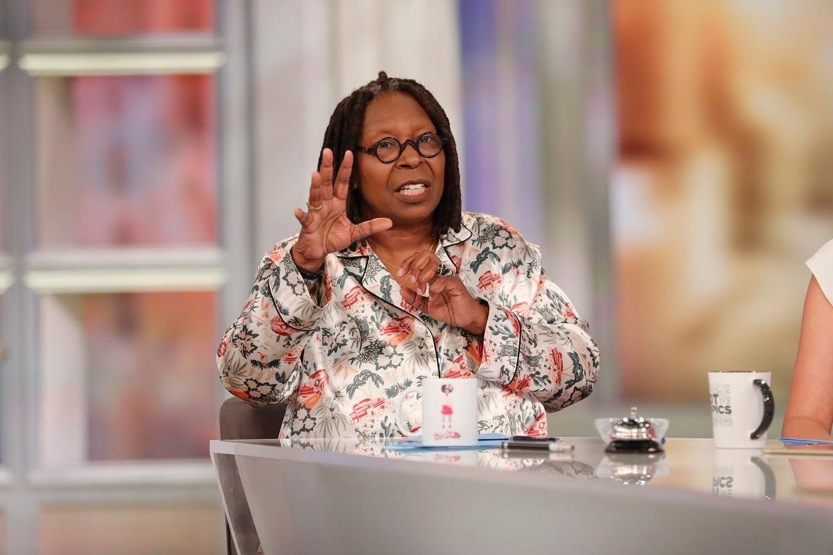 'The View' moderator Whoopi Goldberg wearing a black and white blouse; sits at the Hot Topics table.