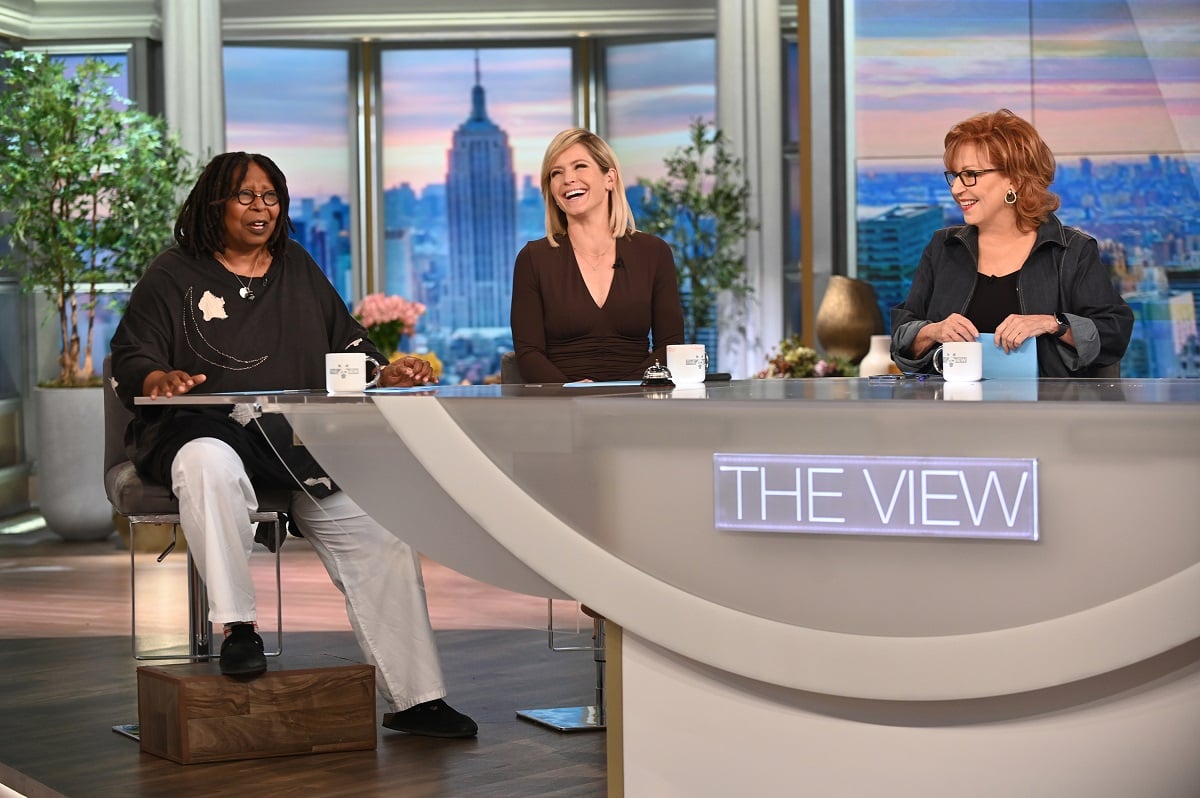 'The View' cast members Whoopi Goldberg, Sara Haines, and Joy Behar sitting on set of the talk show.