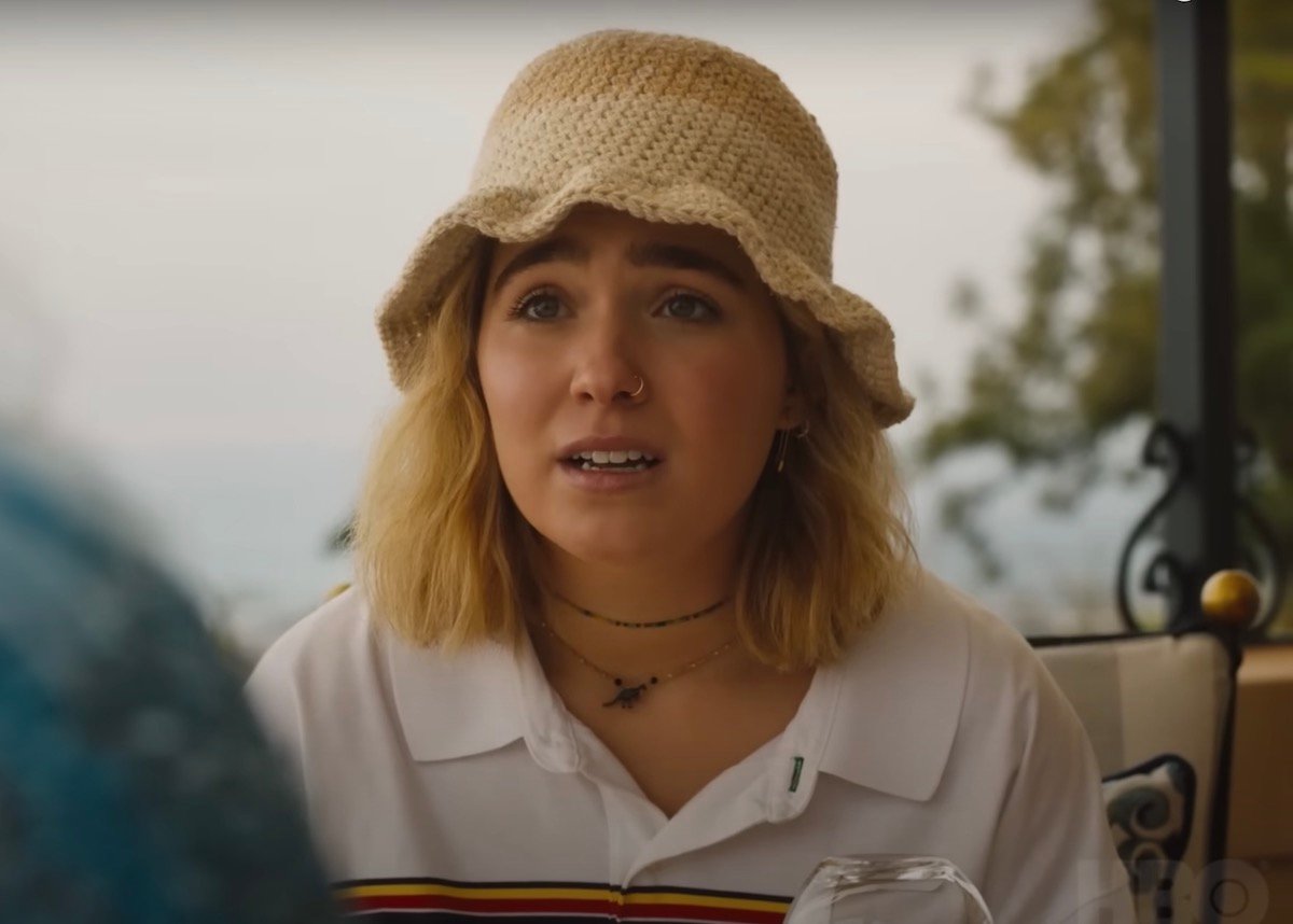 Haley Lu Richardson wears a crocheted bucket hat while filming a scene for The White Lotus