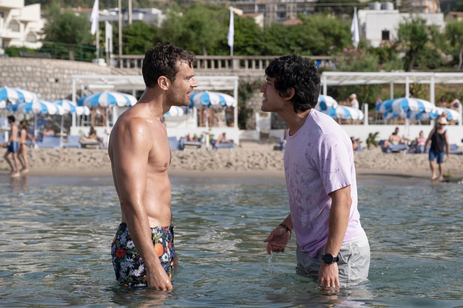 Theo James and Will Sharpe in 'The White Lotus' Season 2 Episode 7, 'Arrivederci.' They're standing in the ocean and yelling at each other.