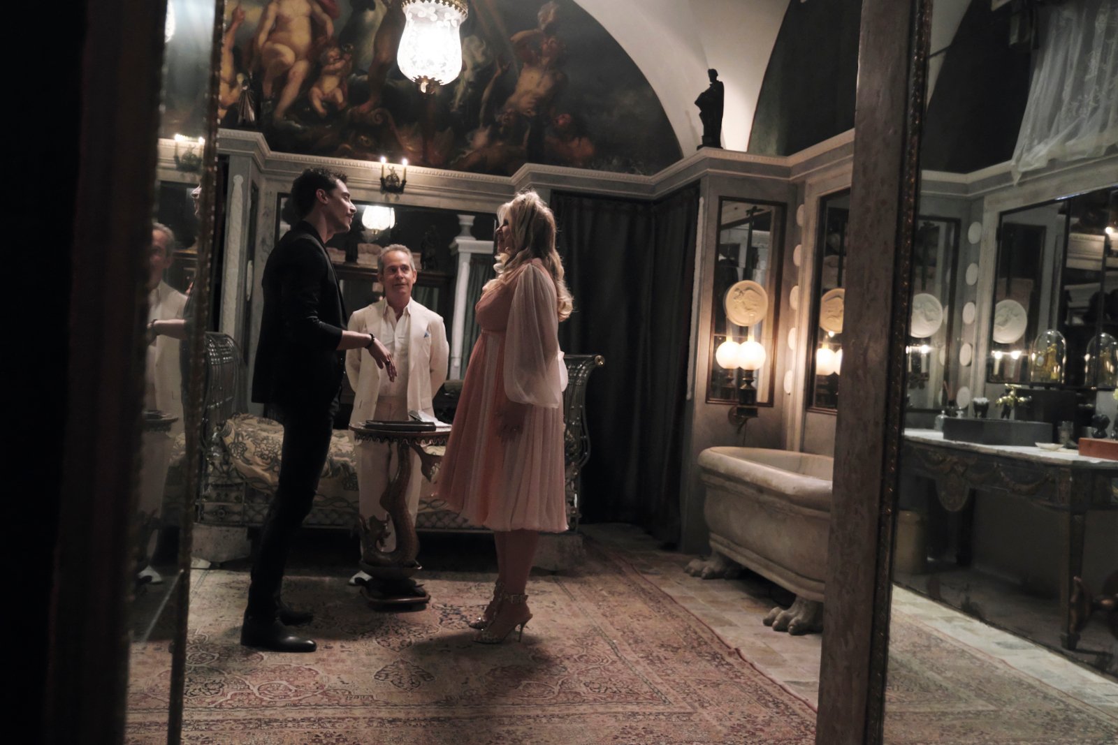 Stefano Gianino, Tom Hollander, and Jennifer Coolidge in 'The White Lotus' Season 2. They're standing in a circle and talking to one another.