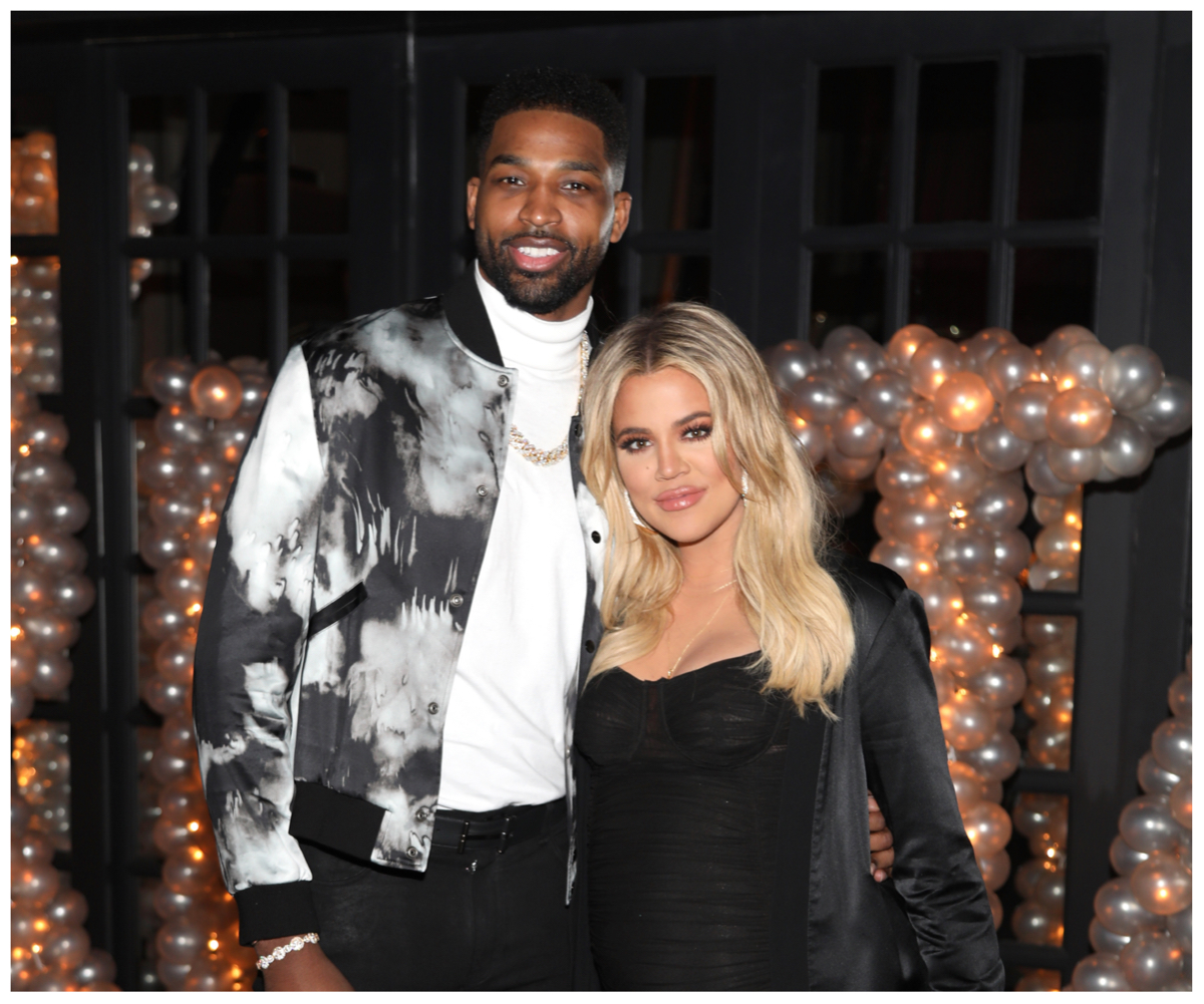 Tristan Thompson and Khloé Kardashian smile and pose together at an event.