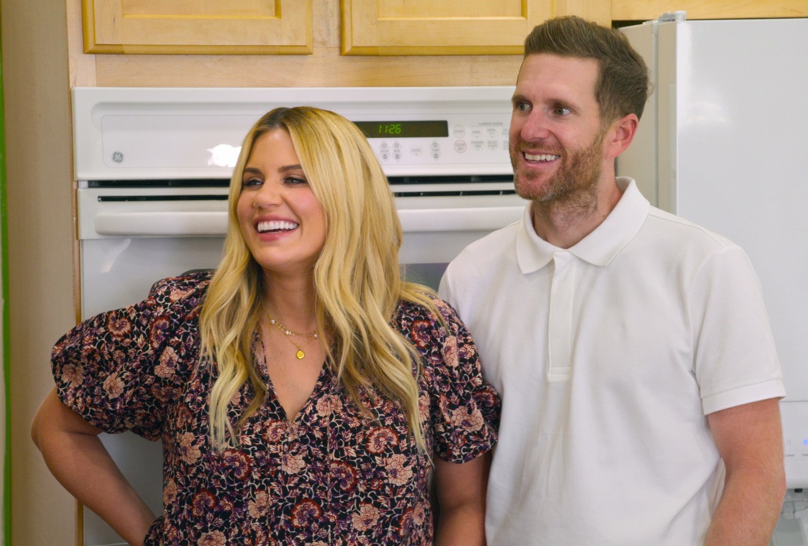 Shea 0and Syd McGee in 'Dream Home Makeover' for our article about season 4. They're standing in front of cabinets and an oven and smiling.