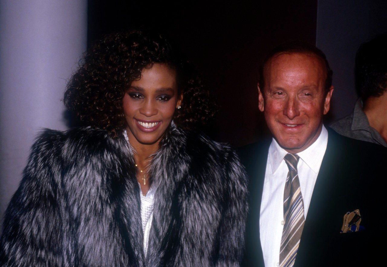 Whitney Houston and Clive Davis smile in photo