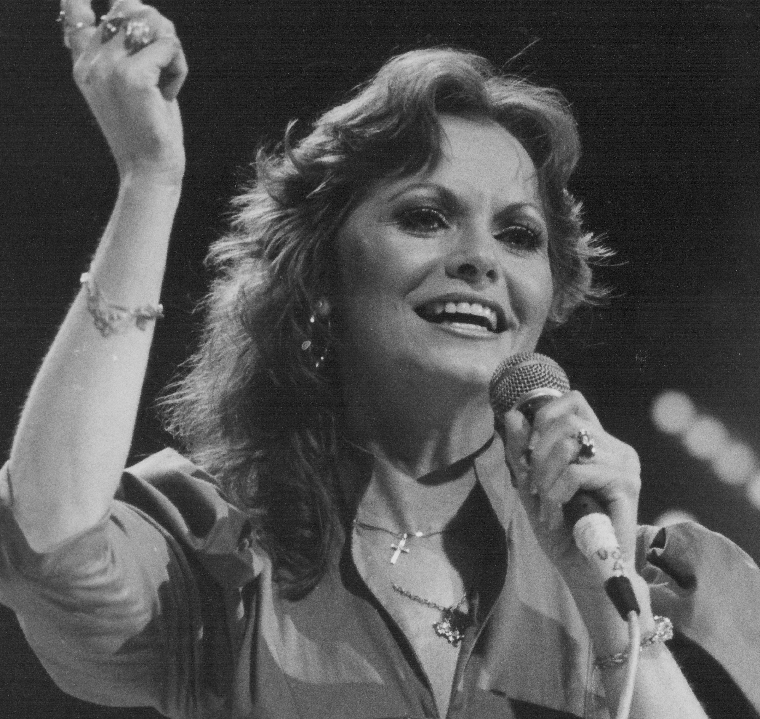 "Harper Valley PTA" singer Jeannie C. Riley with a microphone