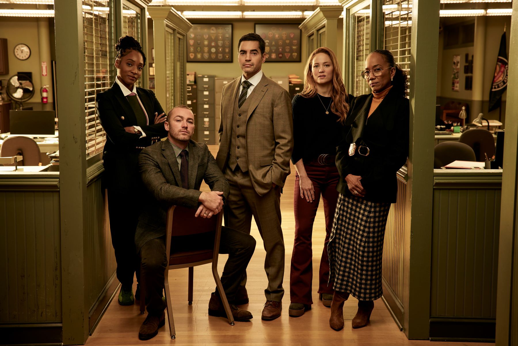 Iantha Richardson as Faith Mitchell, Jake McLaughlin as Michael Ormewood, Ramón Rodrìguez as Will Trent, Erika Christensen as Angie Polaski, and Sonja Sohn as Amanda Wagner pose for promotional pictures for 'Will Trent' on ABC. Faith wears a black suit. Michael wears a dark brown suit. Will wears a brown three-piece suit. Angie wears a black sweater and red pants. Amanda wears a black suit and black and white plaid skirt.