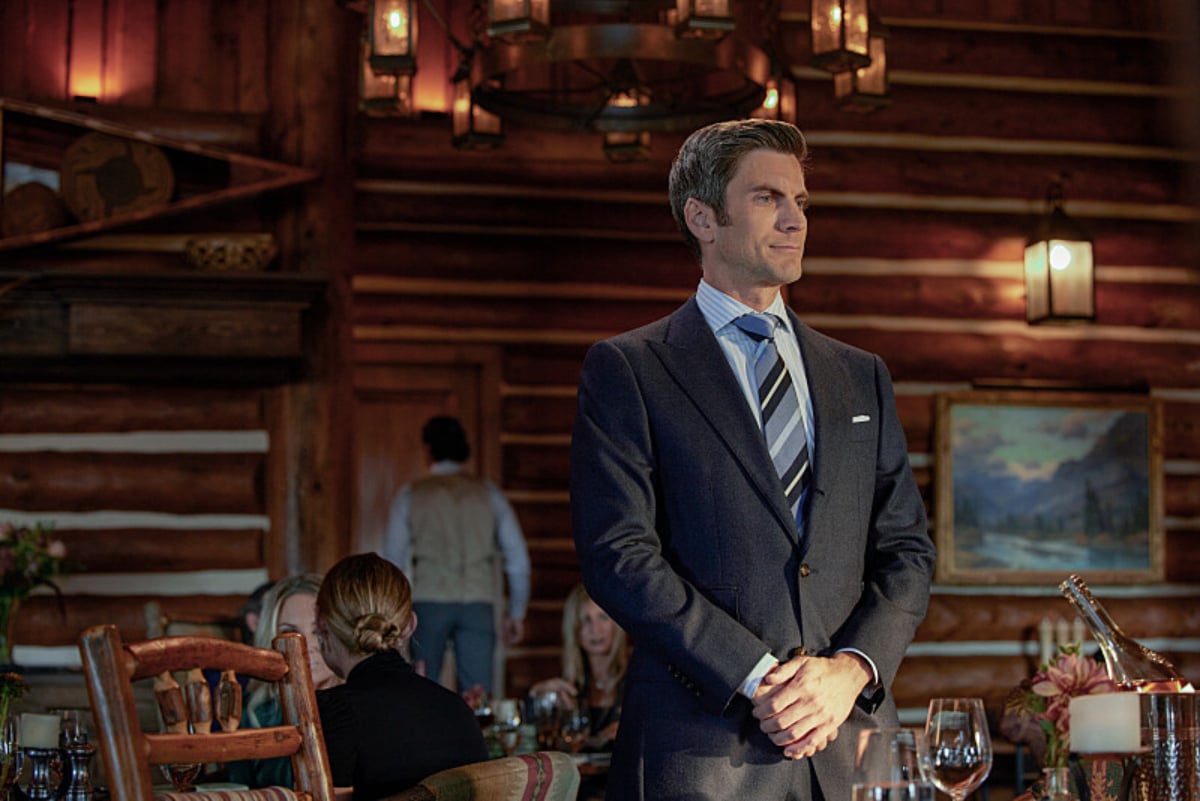 In Yellowstone Season 5, Sarah Atwood and Jamie are in a troublesome romantic relationship. Jamie stands in John's house wearing a suit and tie. 