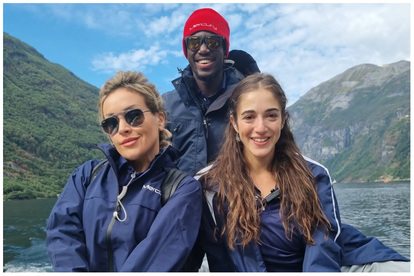 Faye Clarke, Oriana Schneps and Nathan Morley from Below Deck Adventure on a tender in front of a mountain 