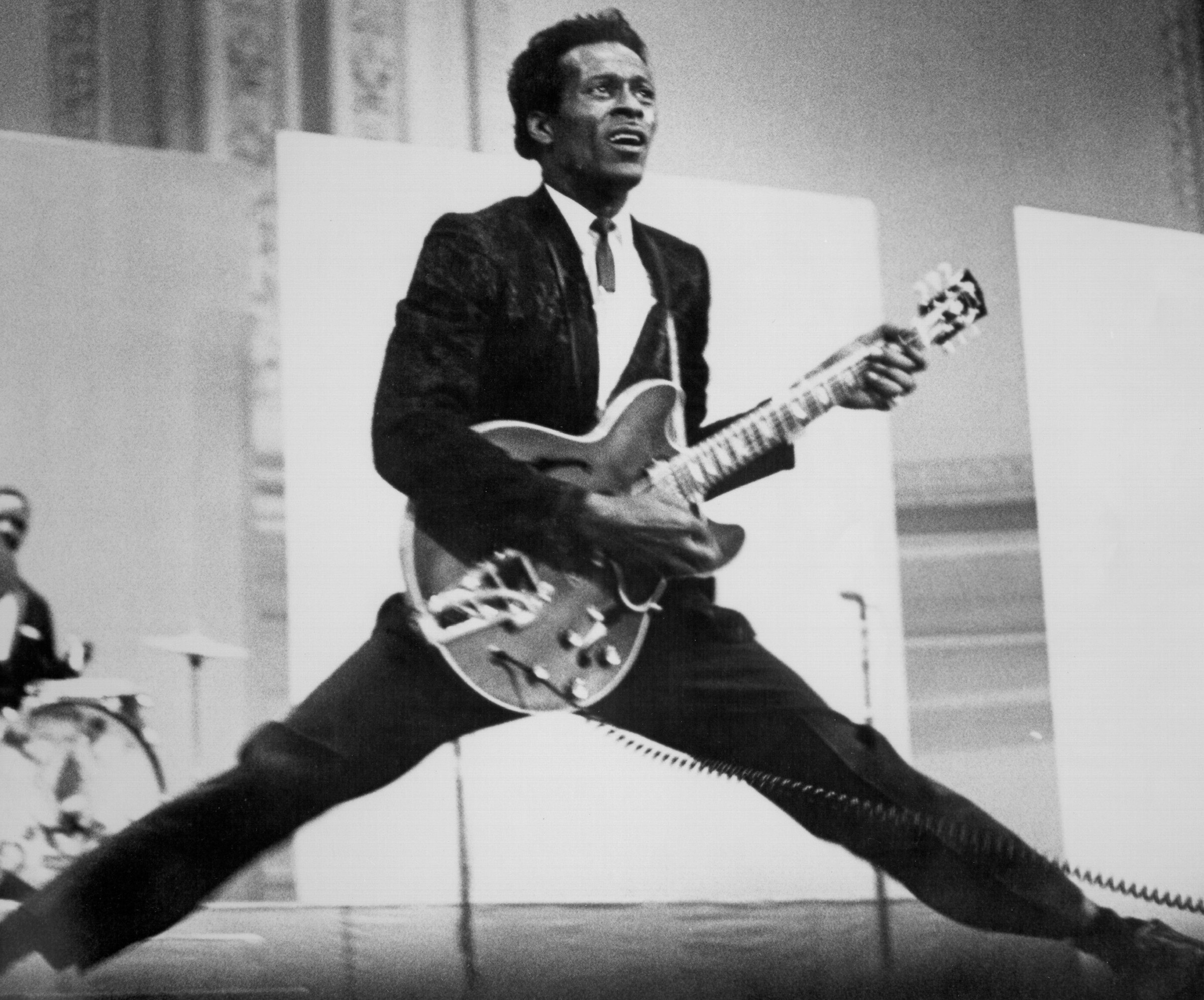 Chuck Berry holding a guitars