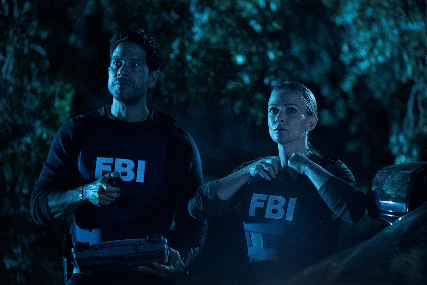 Adam Rodriguez as Luke Alvez and A.J. Cook as JJ wearing bulletproof vests at night in Criminal Minds: Evolution Episode 5