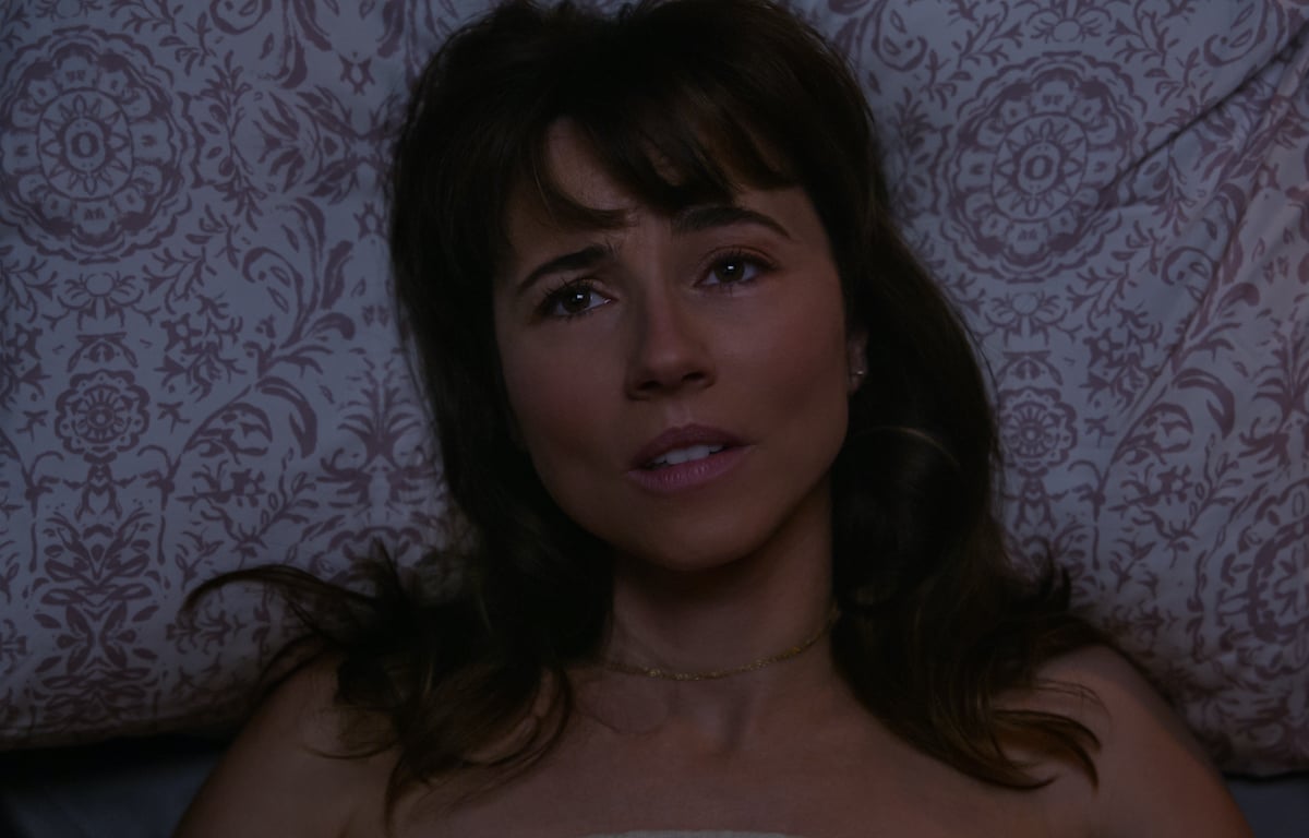 Judy (Linda Cardellini) lays in bed looking up at the ceiling in 'Dead to Me' Season 3