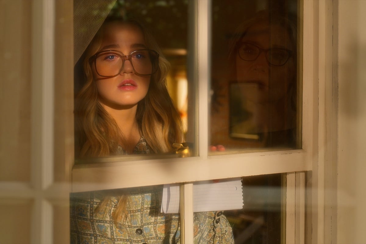 Young Kate (Roan Curtis) peers out the window in a shot from the first five minutes of 'Firefly Lane' Season 2