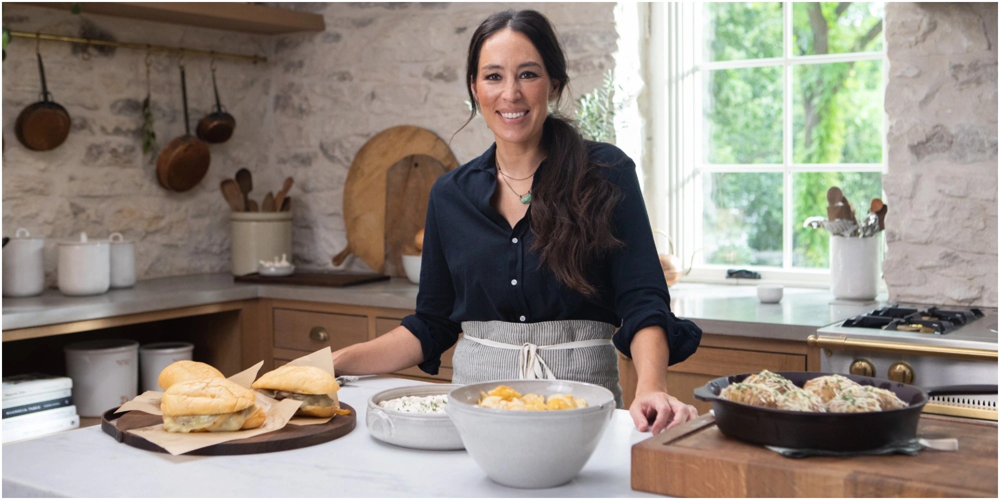 Joanna Gaines cooks in the kitchen of her discovery+ show.