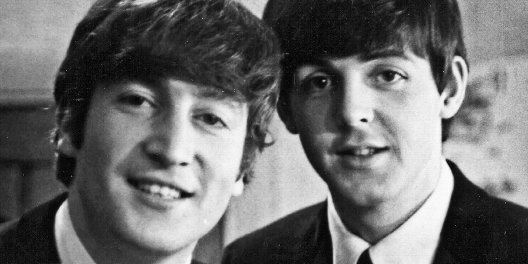 John Lennon and Paul McCartney from The Beatles posed backstage at the Finsbury Park Astoria, London during the band's Christmas Show residency on 30th December 1963.