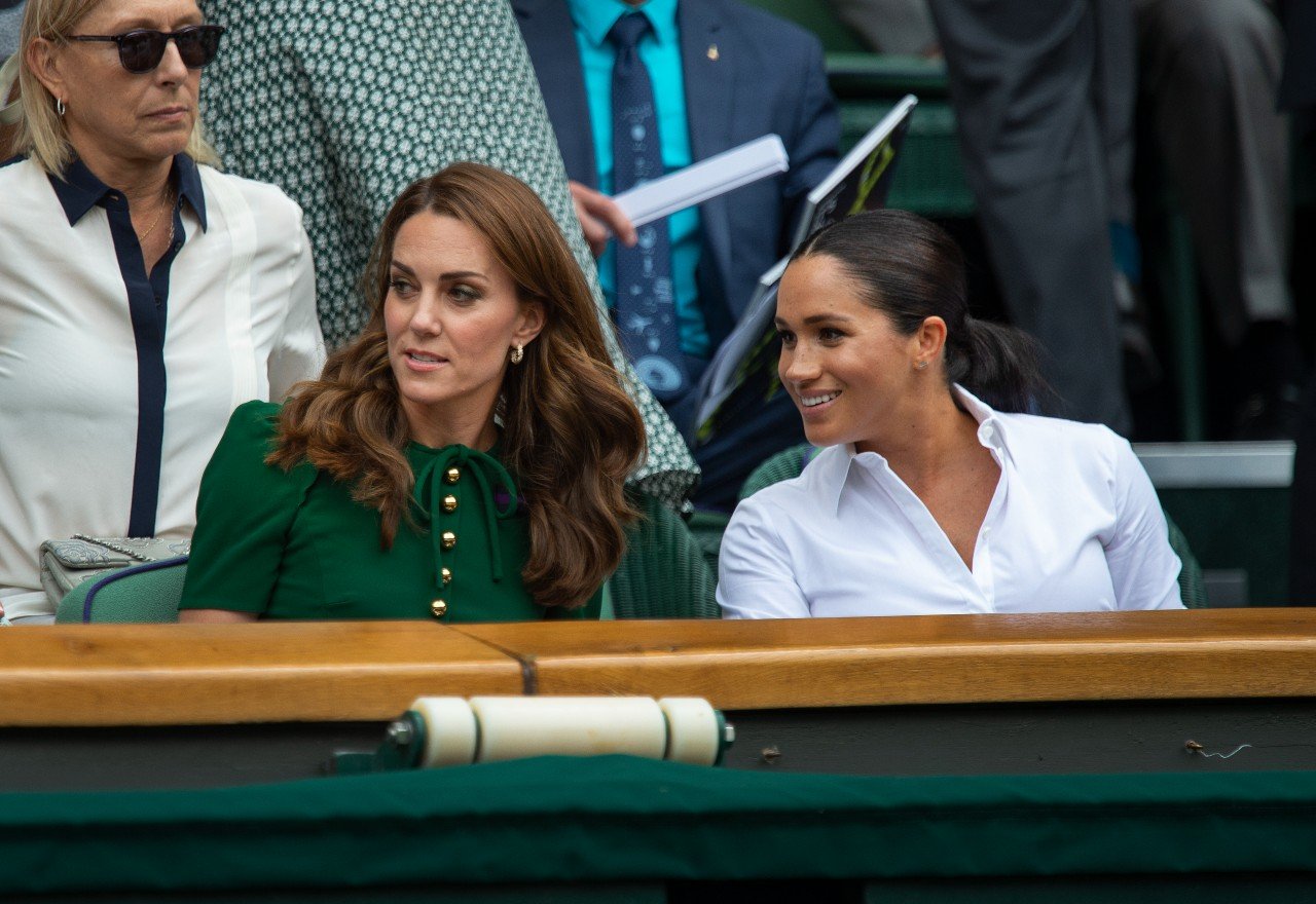 Kate Middleton and Meghan Markle attend an event.