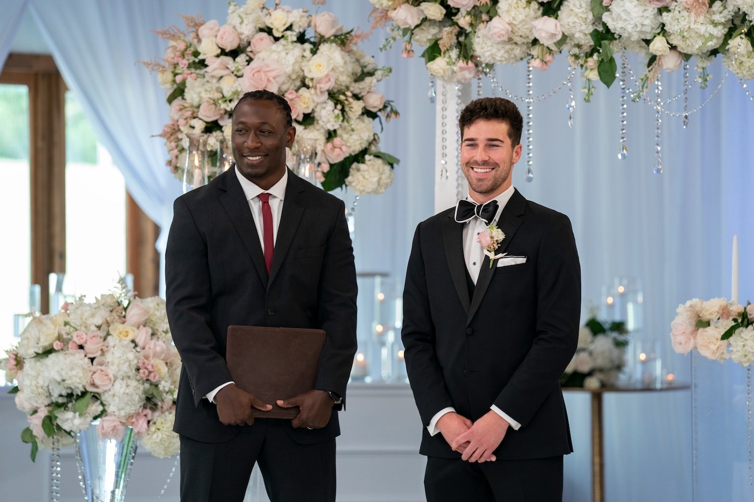 'Love Is Blind' cast member Cole Barnett stands with the officiant wearing a tuxedo on his wedding day.