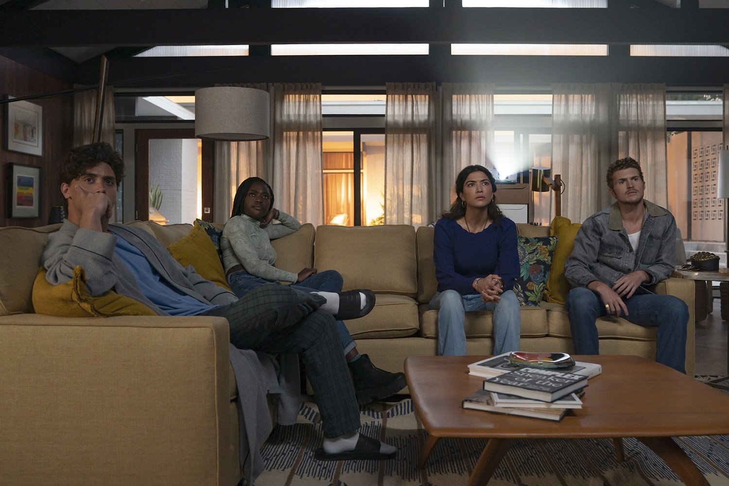 National Treasure: Edge of History: Antonio Cipriano as Oren, Zuri Reed as Tasha, Lisette Olivera as Jess, and Jake Austin Walker as Liam sitting on the couch and looking up at something