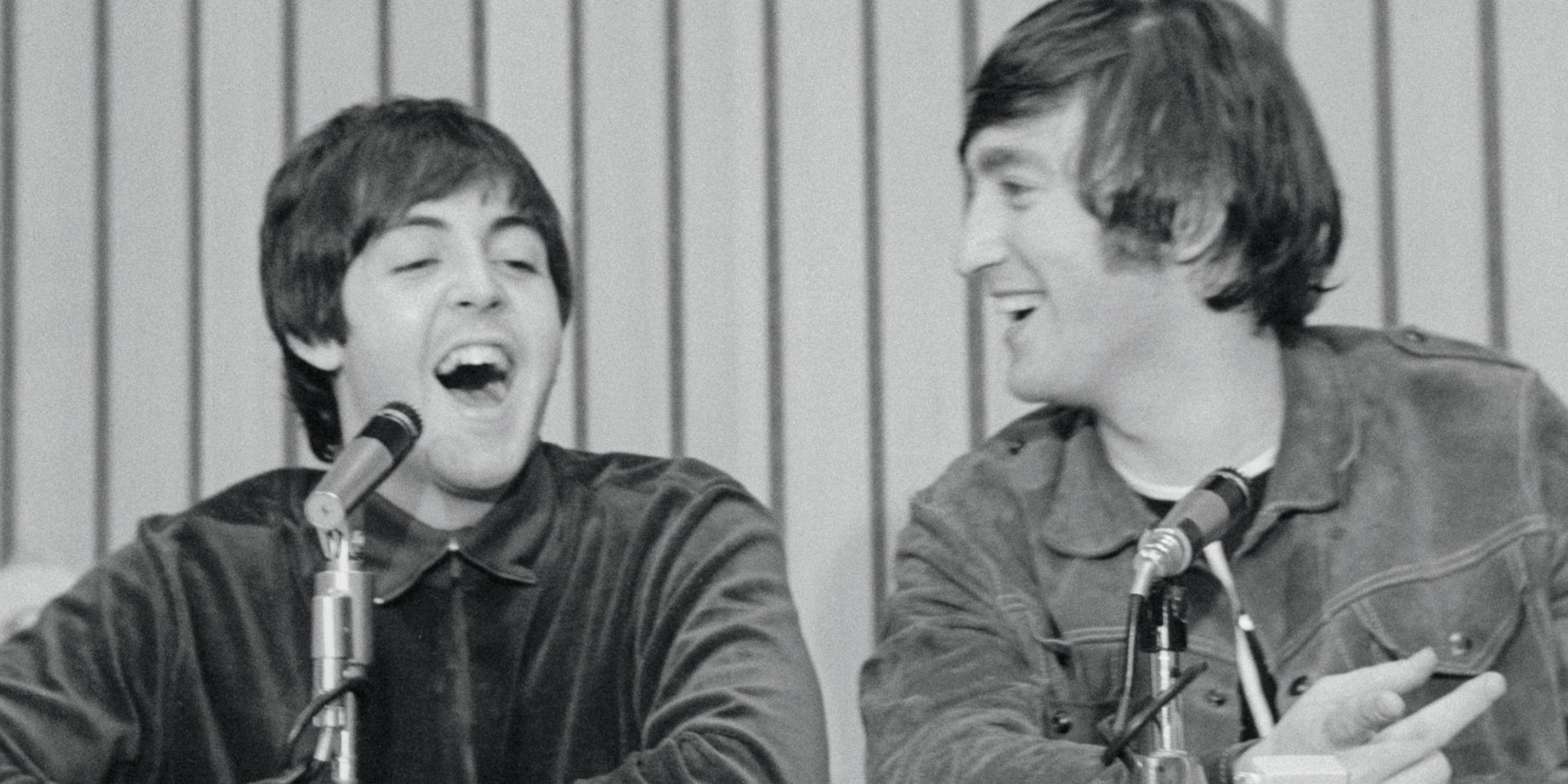 Paul McCartney and John Lennon smiles as Paul McCartney speaks at press conference held after Beatles performance in Portland.