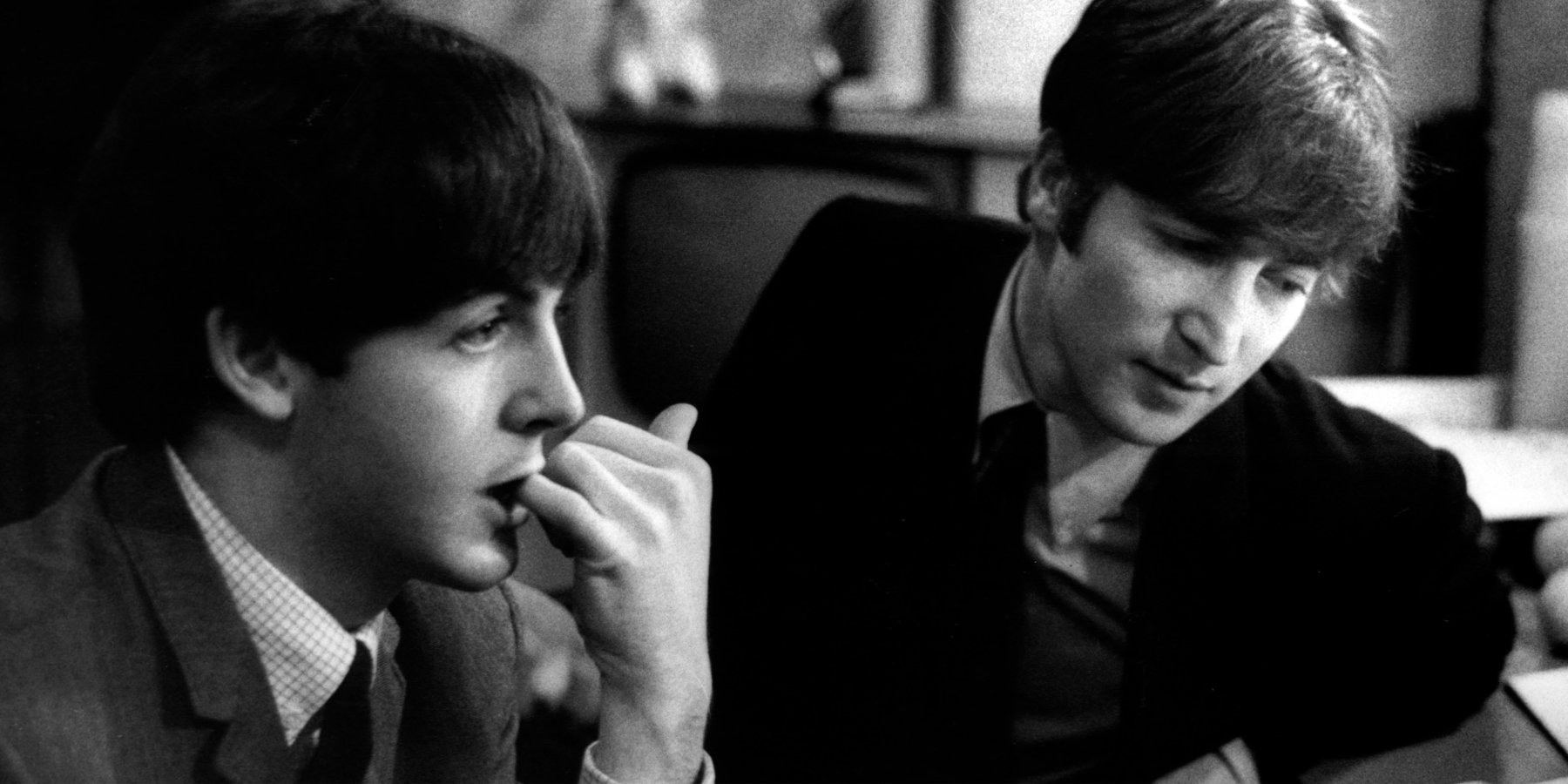 Paul McCartney and John Lennon pose in a vintage Beatles photo taken in 1963.
