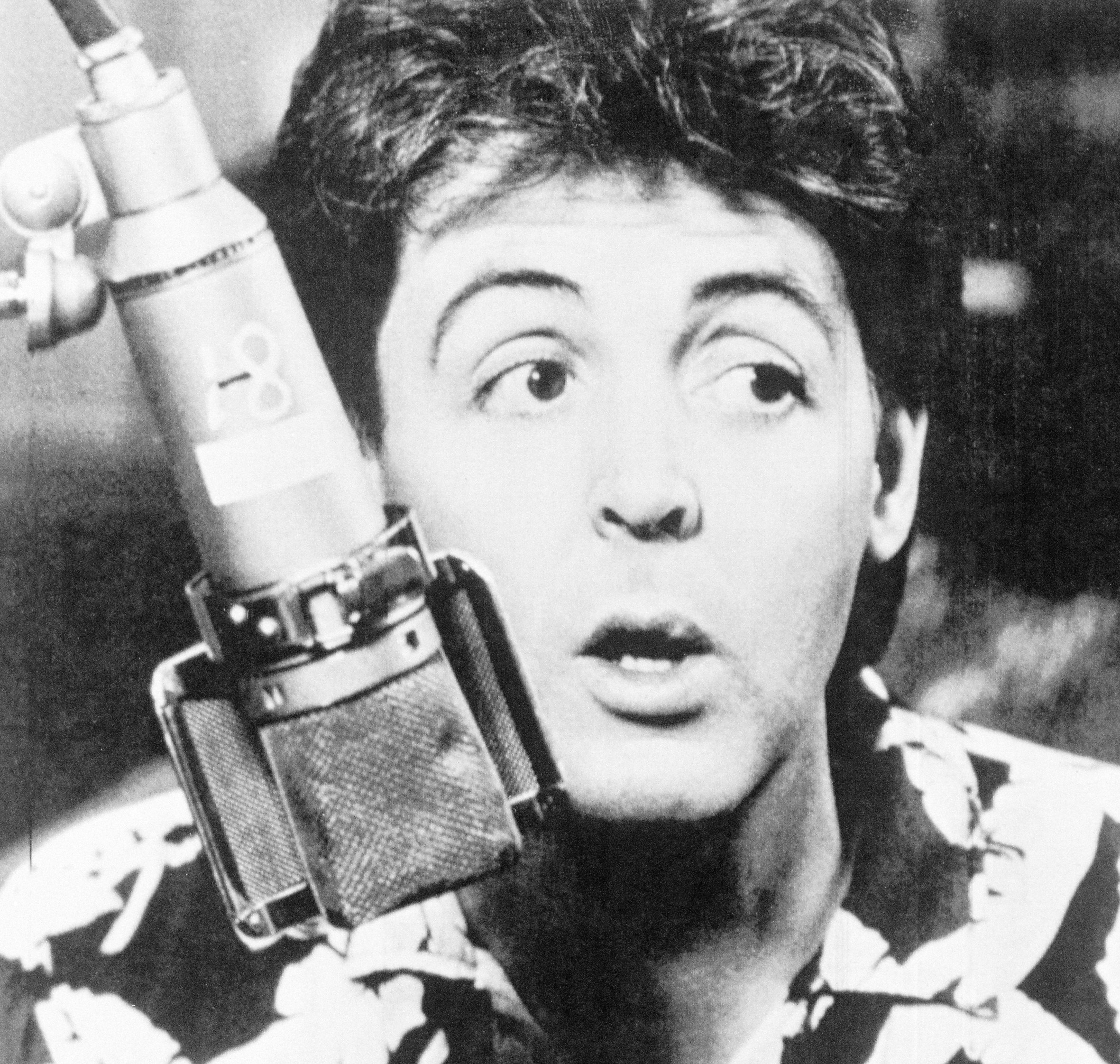 Paul McCartney with a microphone during his "Wonderful Christmastime" era