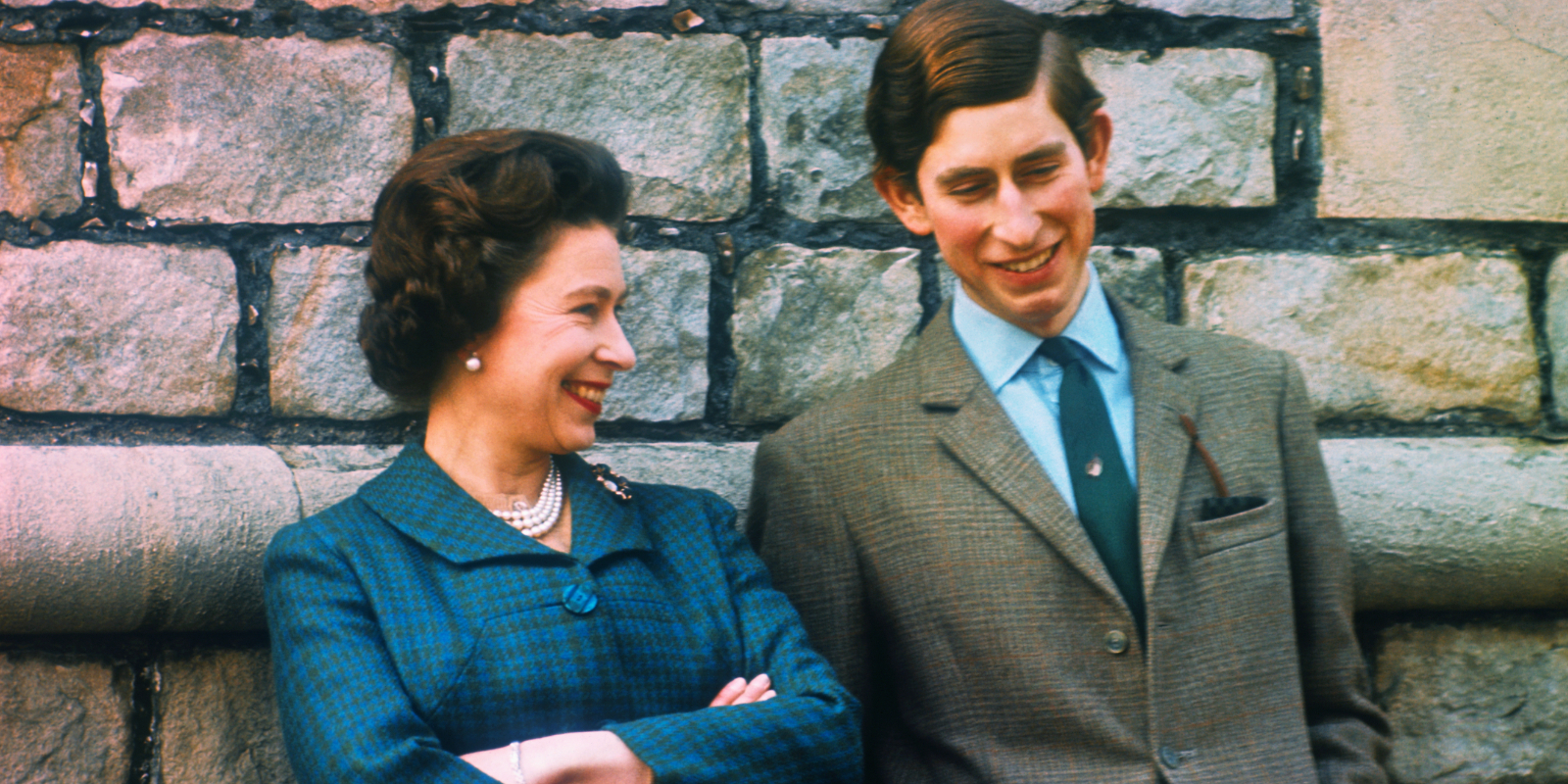 Queen Elizabeth and then-Prince Charles outside of their Windsor home in an older, undated file photo.