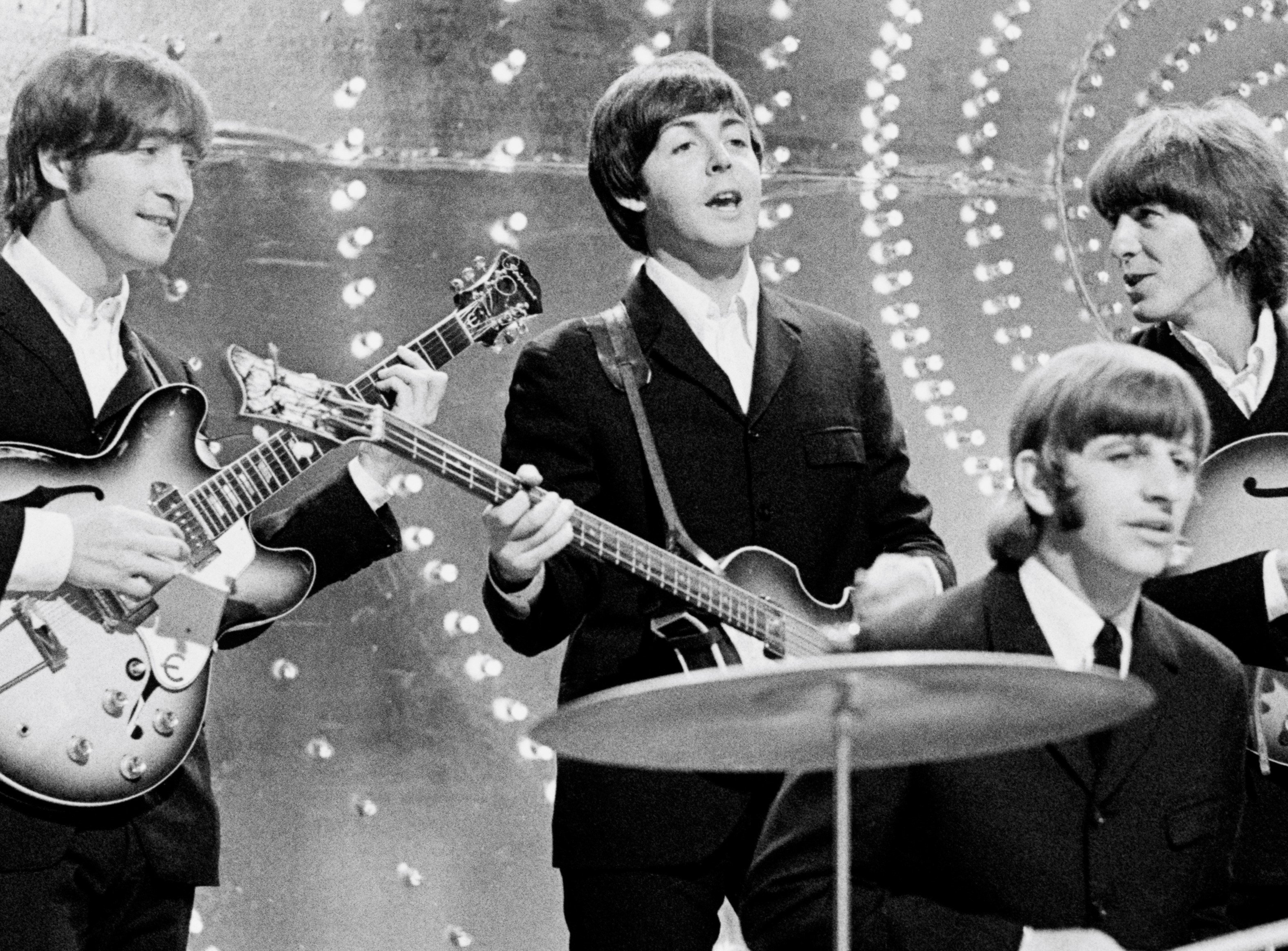 The Beatles playing instruments during the "Twist and Shout" era