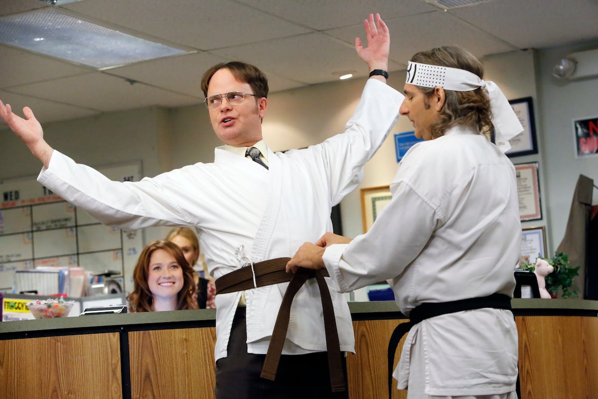 Sensei Billy (Michael Imperioli) ties Dwight's (Rainn Wilson) black belt around his waist in season 9 of 'The Office'