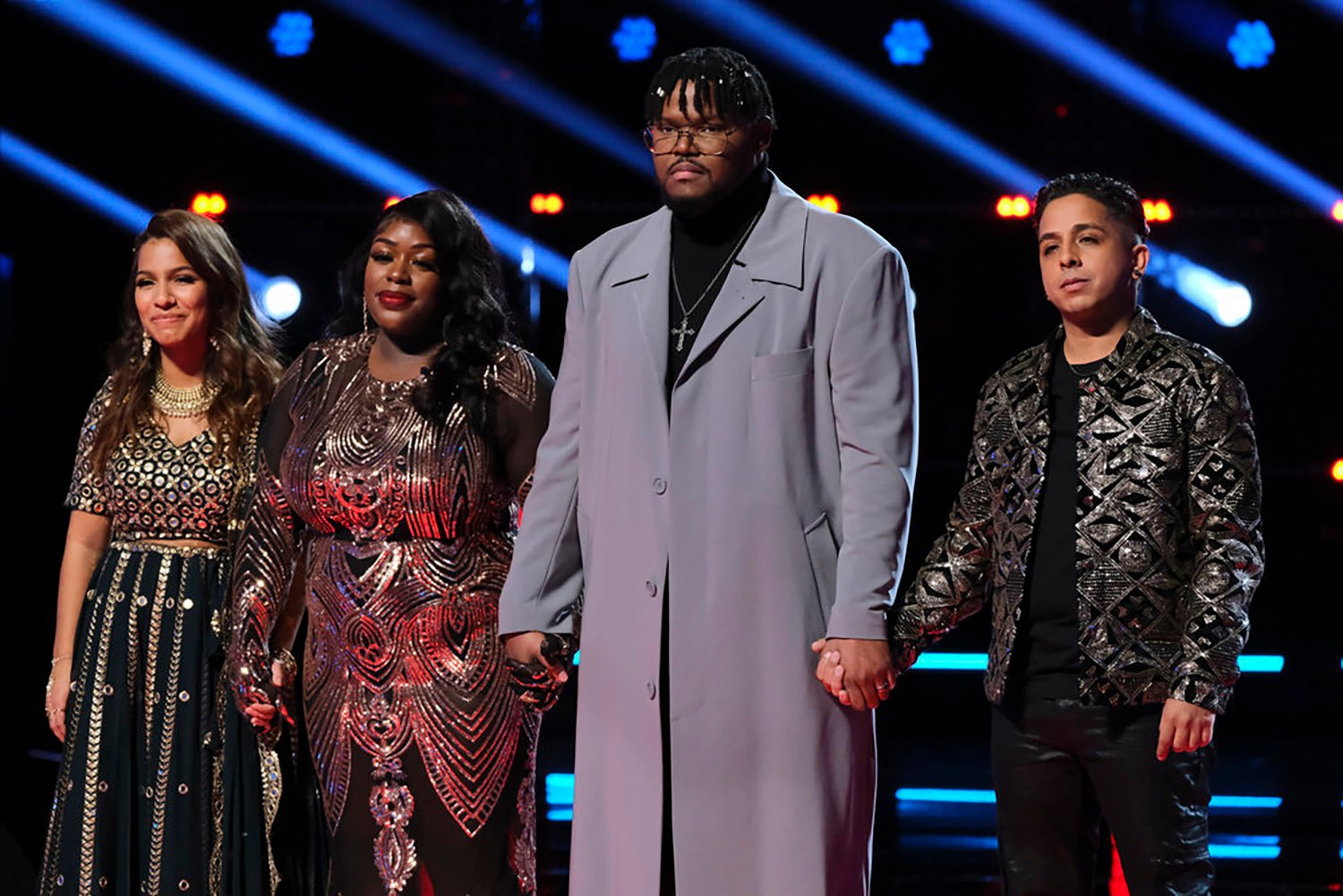 The bottom four artists on The Voice 2022, Parijita Bastola, Kim Cruse, Justin Aaron, and Omar Jose Cardona, await results after fighting for their spot with the other finalists.