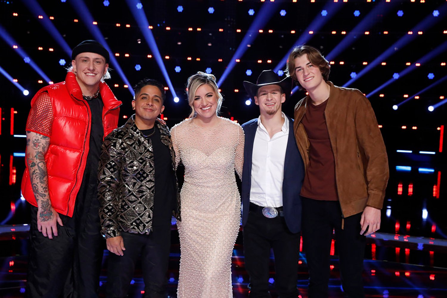The Voice Season 22 winner predictions: The Top 5 artists Bodie, Omar Jose Cardona, Morgan Myles, Bryce Leatherwood, and Brayden Lape huddle together and smile.