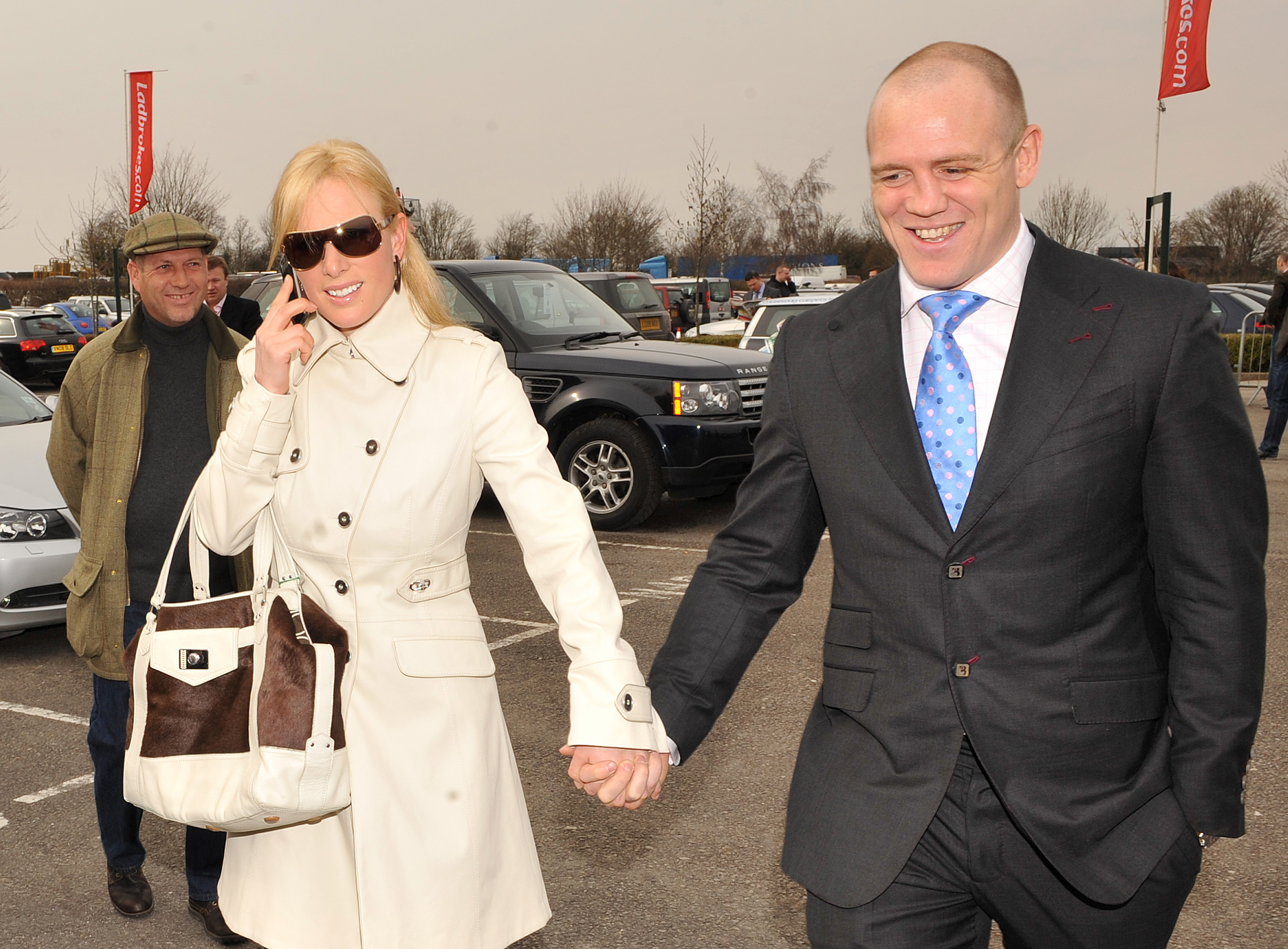 Zara and Mike Tindall hold hands during the Cheltenham Festival.